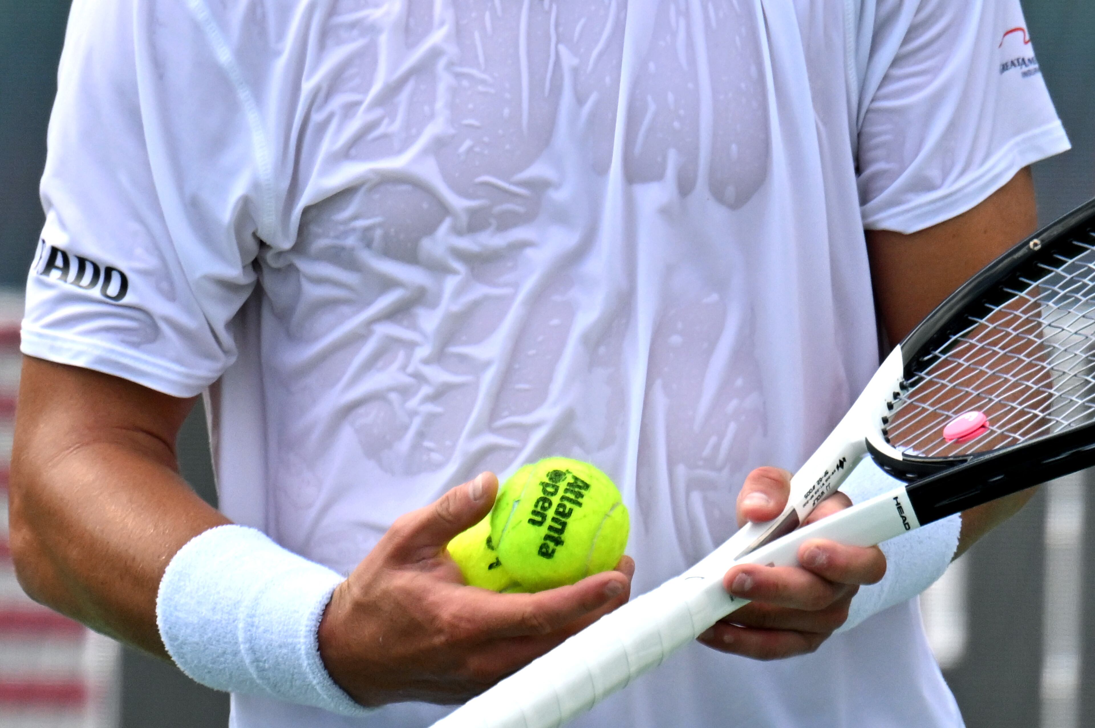 J.J. Wolf holds balls as he prepares to serve against Taylor Fritz during a semifinal match at the 2023 Atlanta Tennis Open at Atlantic Station, Saturday, July 29, 2023, in Atlanta. (Hyosub Shin / Hyosub.Shin@ajc.com)
