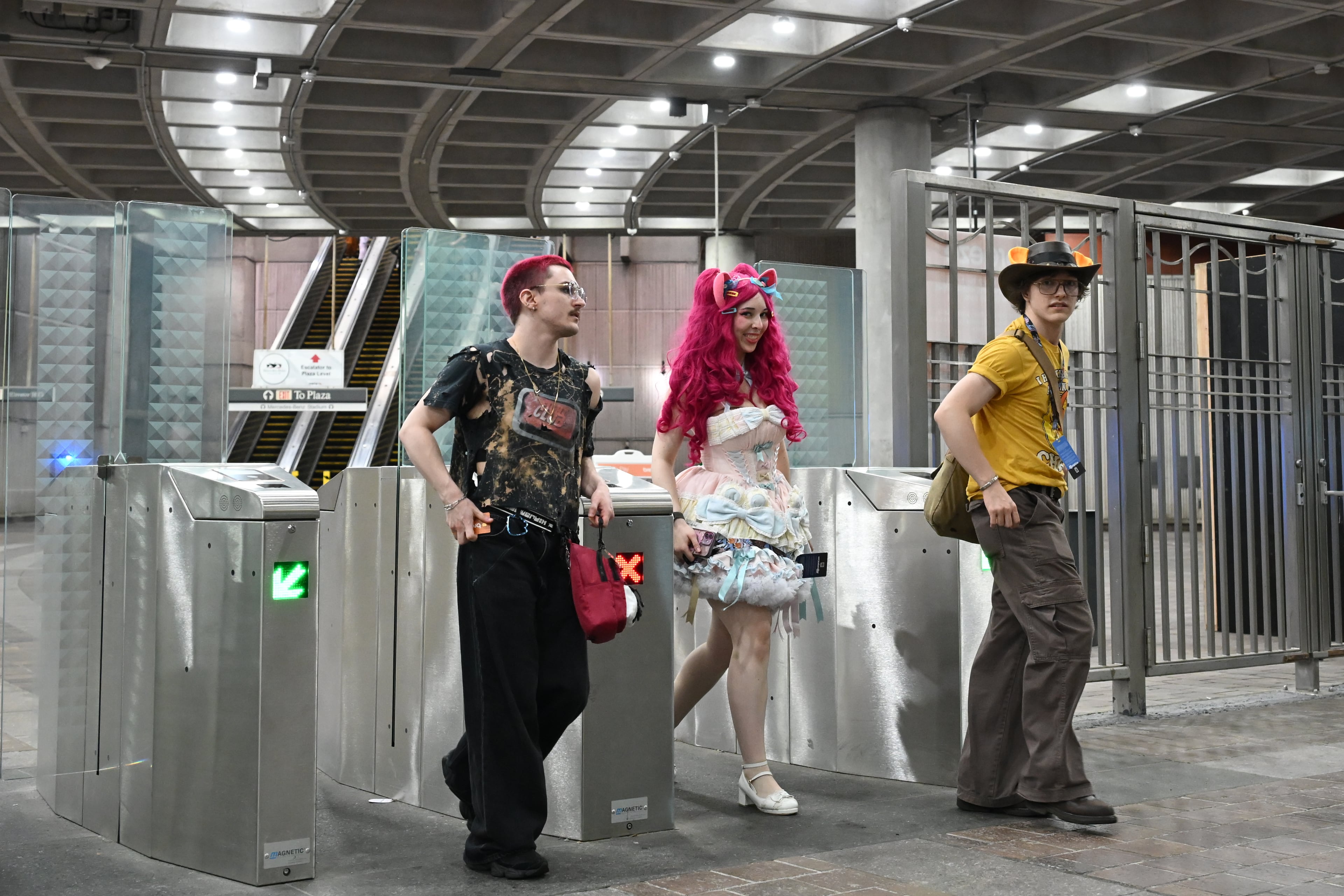 MomoCon attendees pass through turnstiles at the SEC District MARTA station in Atlanta on Friday, May 22, 2026. MomoCon is an annual gaming, animation and art convention held at the Georgia World Congress Center. (Tyler Sun for the AJC)