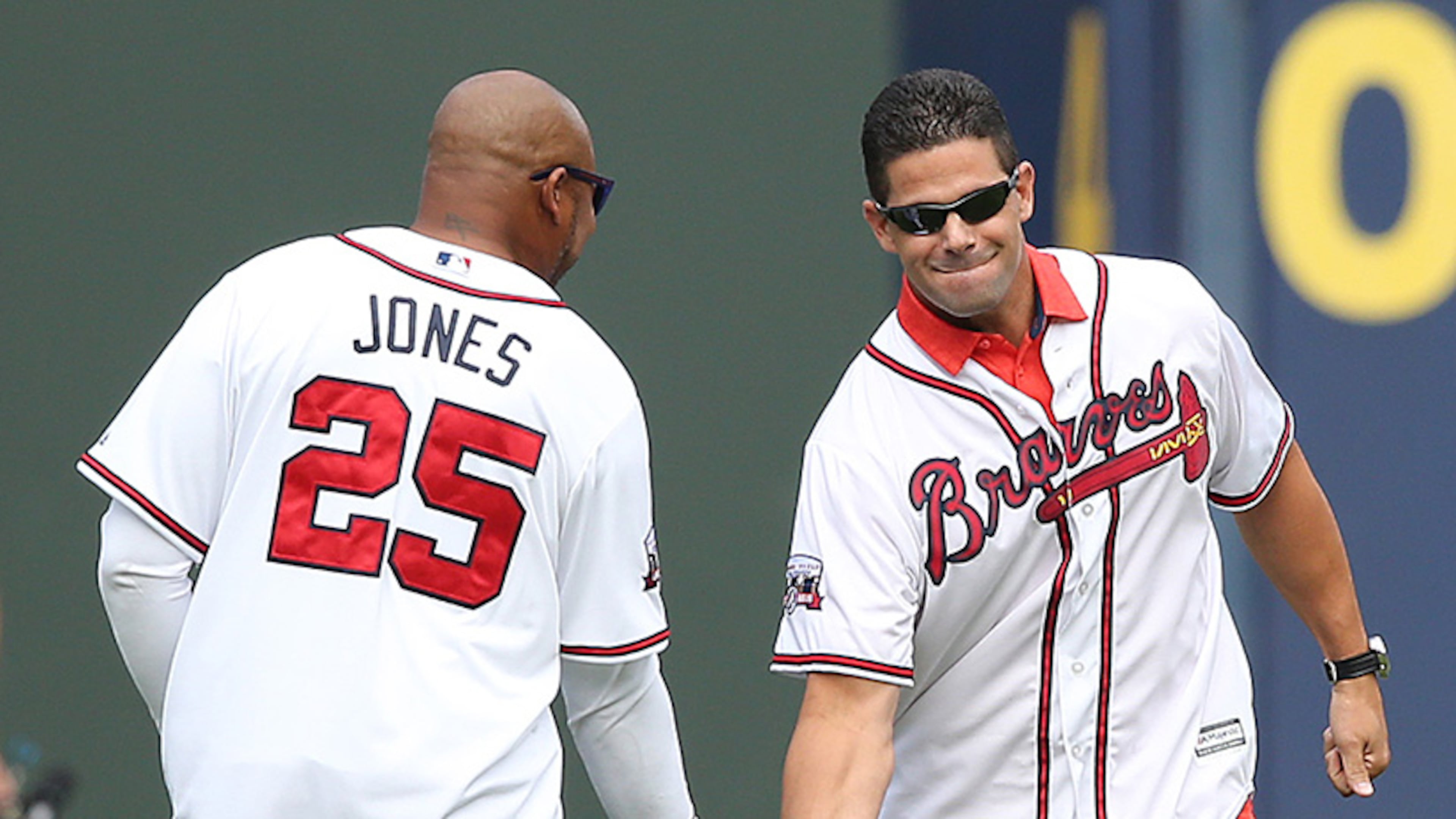 Braves greats Andruw Jones and Javy Lopez give each other five while taking the field for the team's final game at Turner Field on Sunday, Oct. 2, 2016, in Atlanta. (Curtis Compton/AJC)