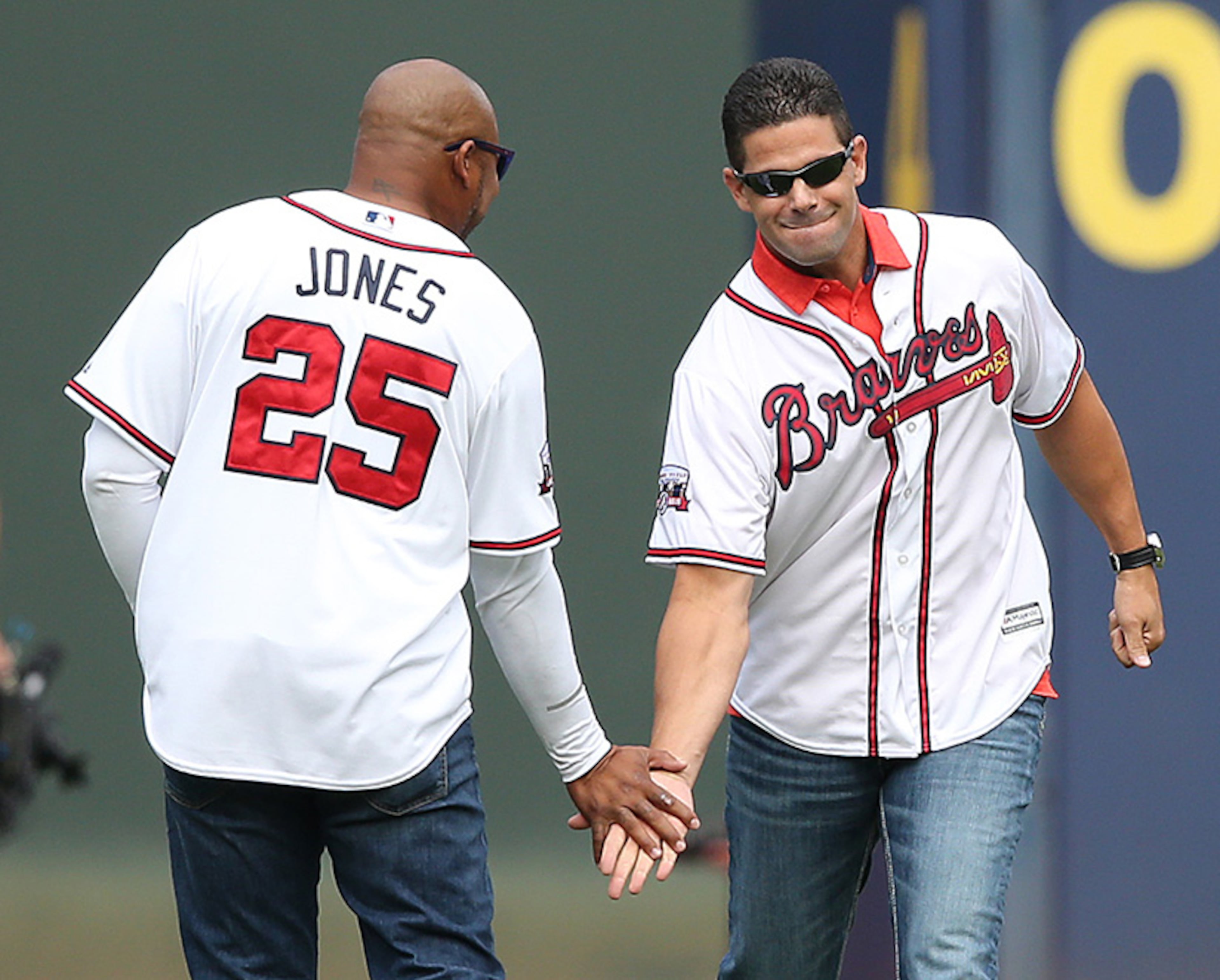 October 02, 2016 Atlanta: Braves greats Andruw Jones and Javy Lopez give each other five while taking the field for the Braves final game at Turner Field on Sunday, Oct. 2, 2016, in Atlanta. Curtis Compton /ccompton@ajc.com