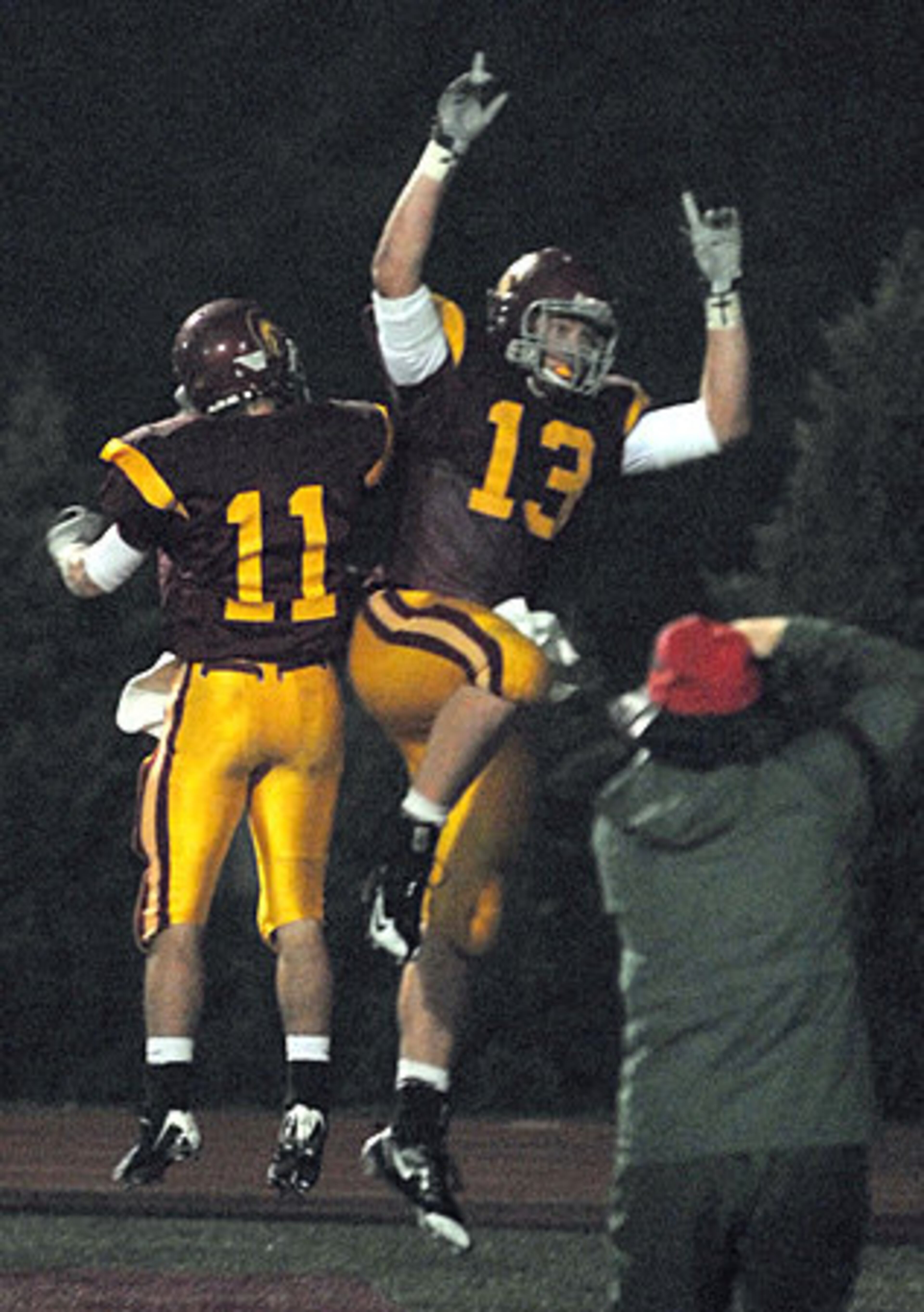 Lassiter's Griffin Lamie (No. 11) and Phillip Lutzenkirchen (No. 13) celebrate a first-quarter touchdown.