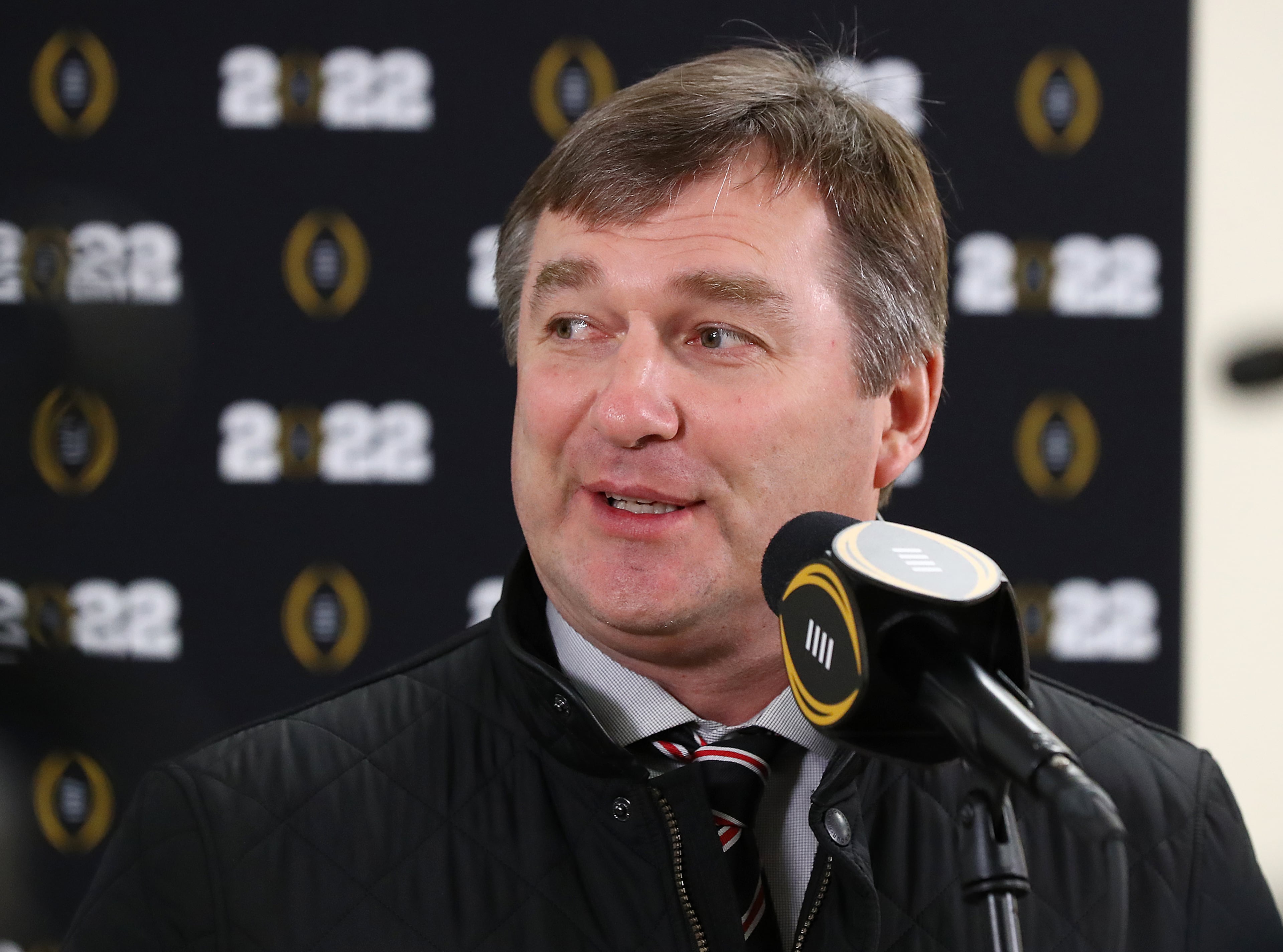 010722 Indianapolis: Georgia head coach Kirby Smart smiles while taking a few questions during the College Football Playoff National Championship team arrivals at Indianapolis Airport on Friday, Jan. 7, 2022, in Indianapolis. “Curtis Compton / Curtis.Compton@ajc.com”`