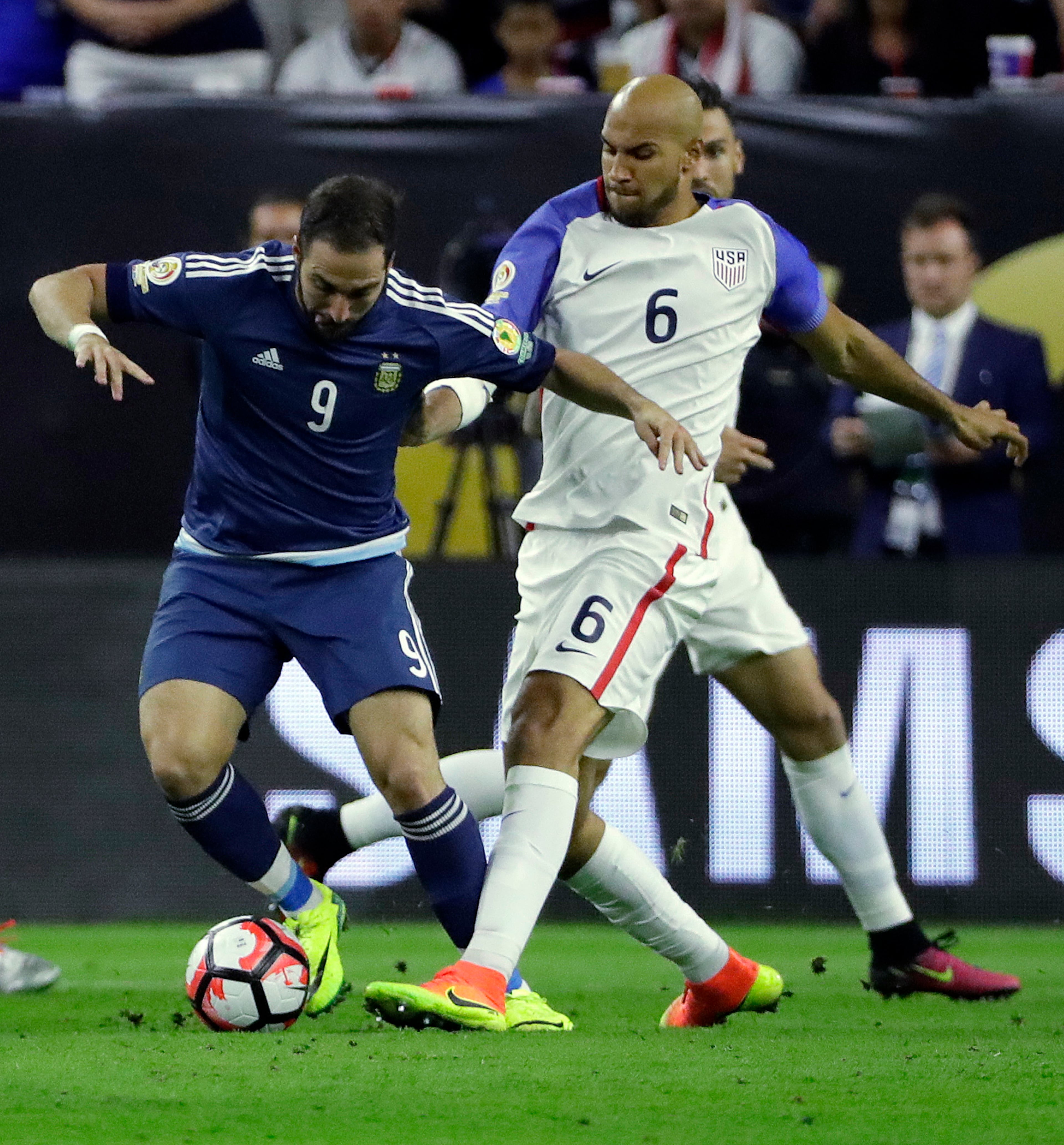 Argentina forward Gonzalo Higuain (9) and United States defender John Brooks (6) go after the ball during a Copa America Centenario semifinal soccer match Tuesday, June 21, 2016, in Houston. (AP Photo/David J. Phillip)