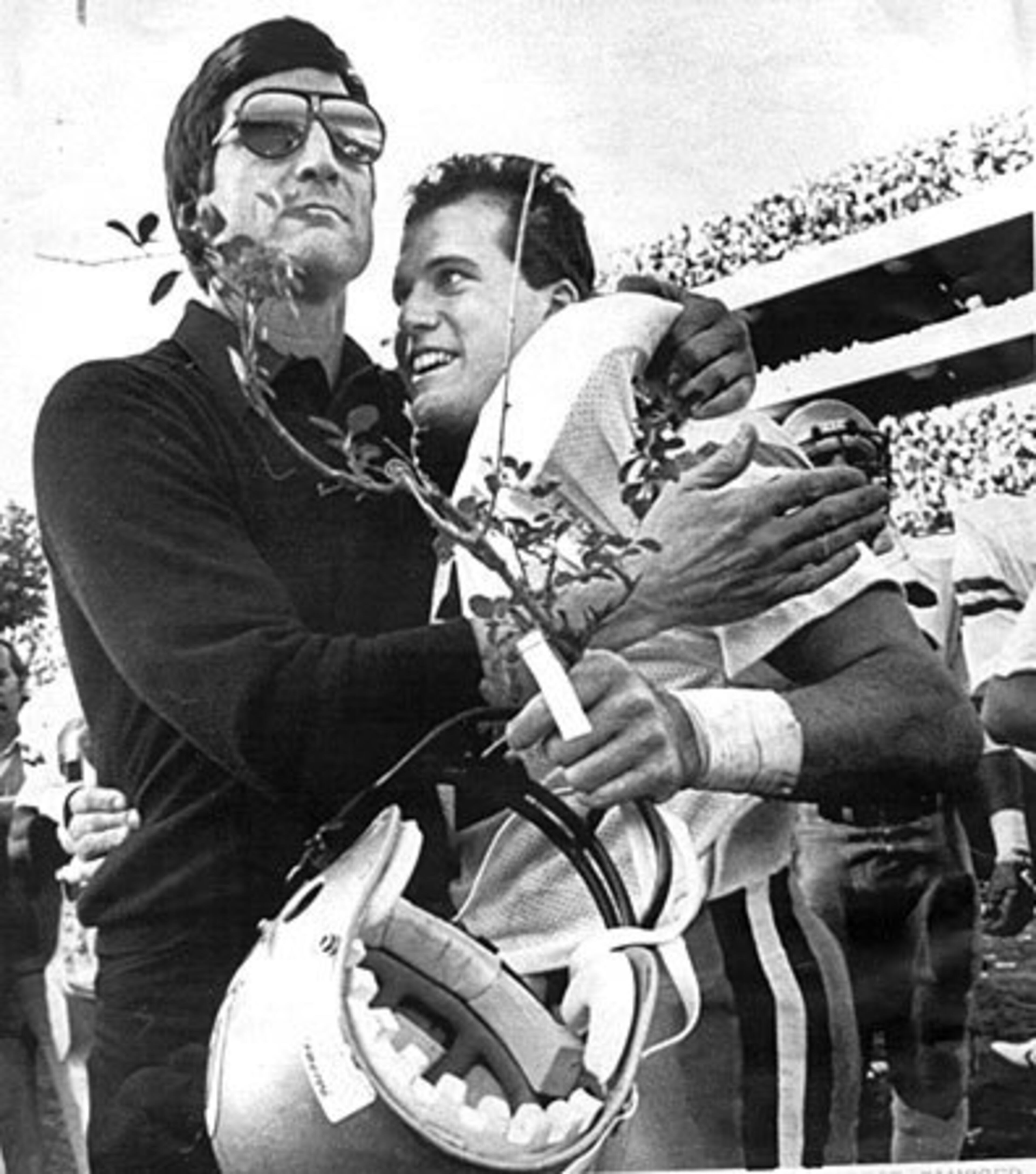1984: Georgia Tech quarterback John Dewberry gets a hug from Curry and a piece of the famed Sanford Stadium hedges following Tech's victory over Georgia in Athens. The Jackets also topped UGA in 1985.