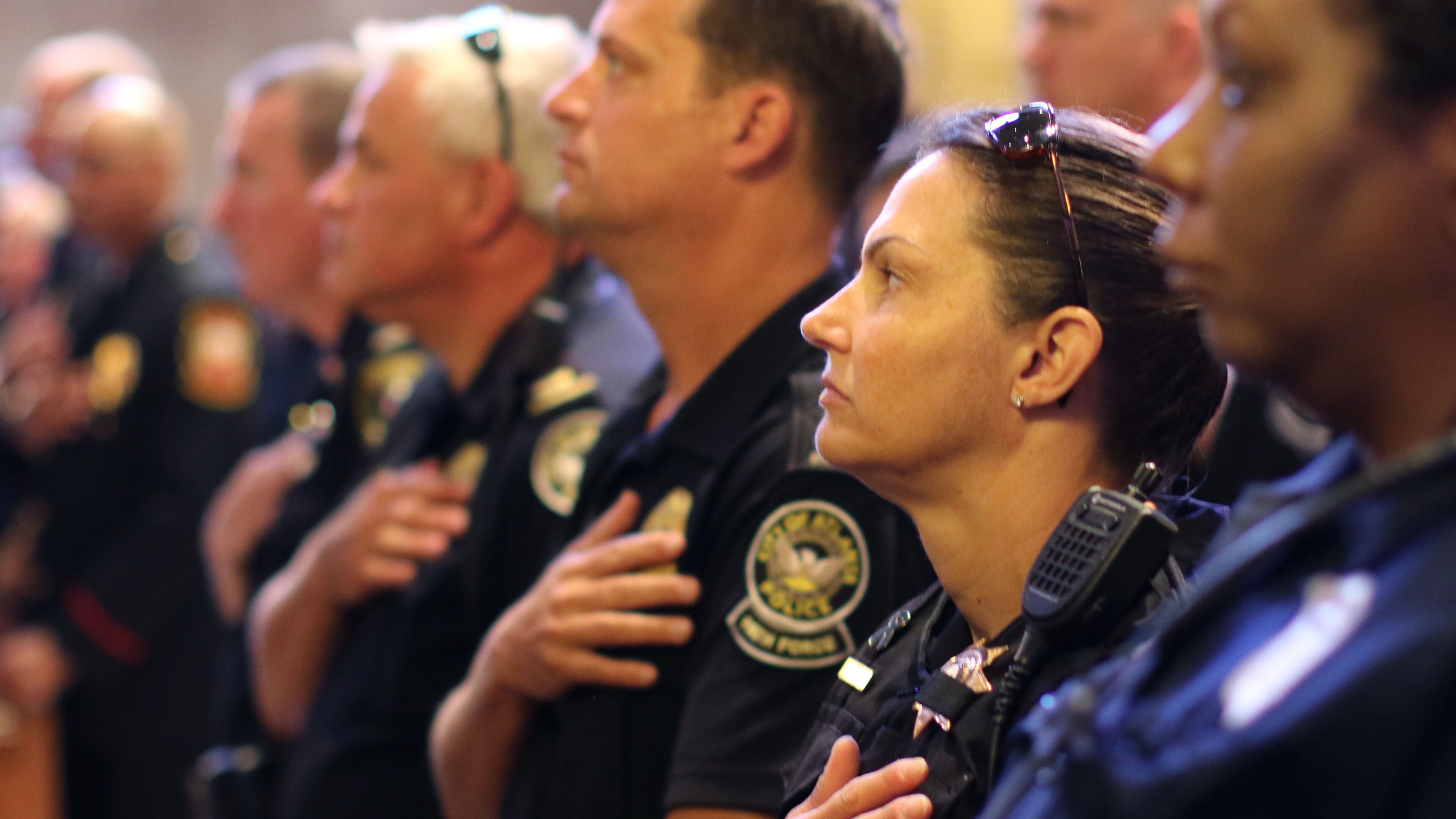 Atlanta’s first responders stand during the presentation of colors and the singing of the National Anthem. The Archdiocese of Atlanta held its first “Blue Mass” for public safety officials and first responders in the archdiocese Friday. BOB ANDRES / BANDRES@AJC.COM