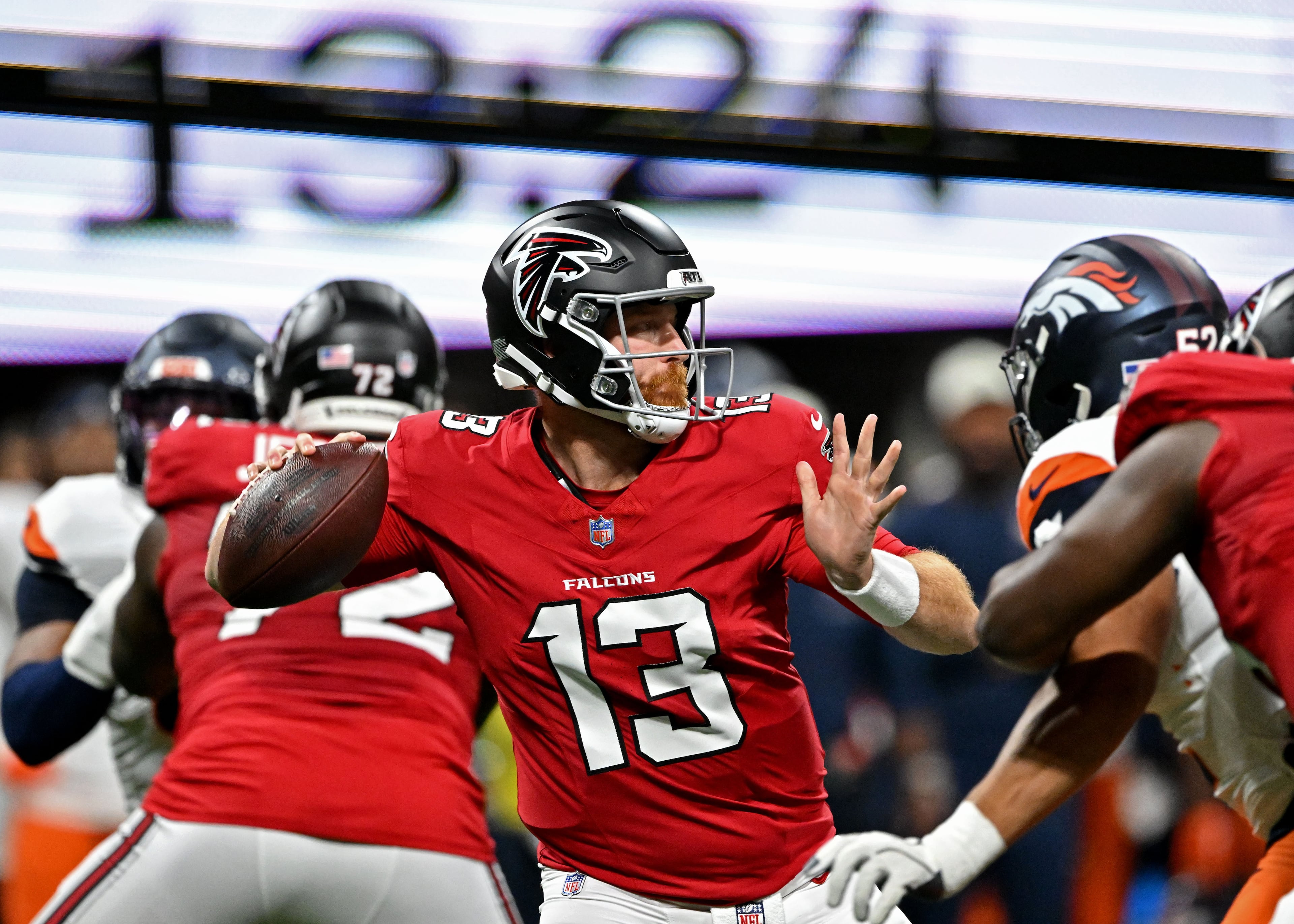 Falcons quarterback Cooper Rush (center) gets off a pass during their preseason game against the Denver Broncos at Mercedes-Benz Stadium on Friday, Aug. 14, 2026, in Atlanta. (Hyosub Shin/AJC)
