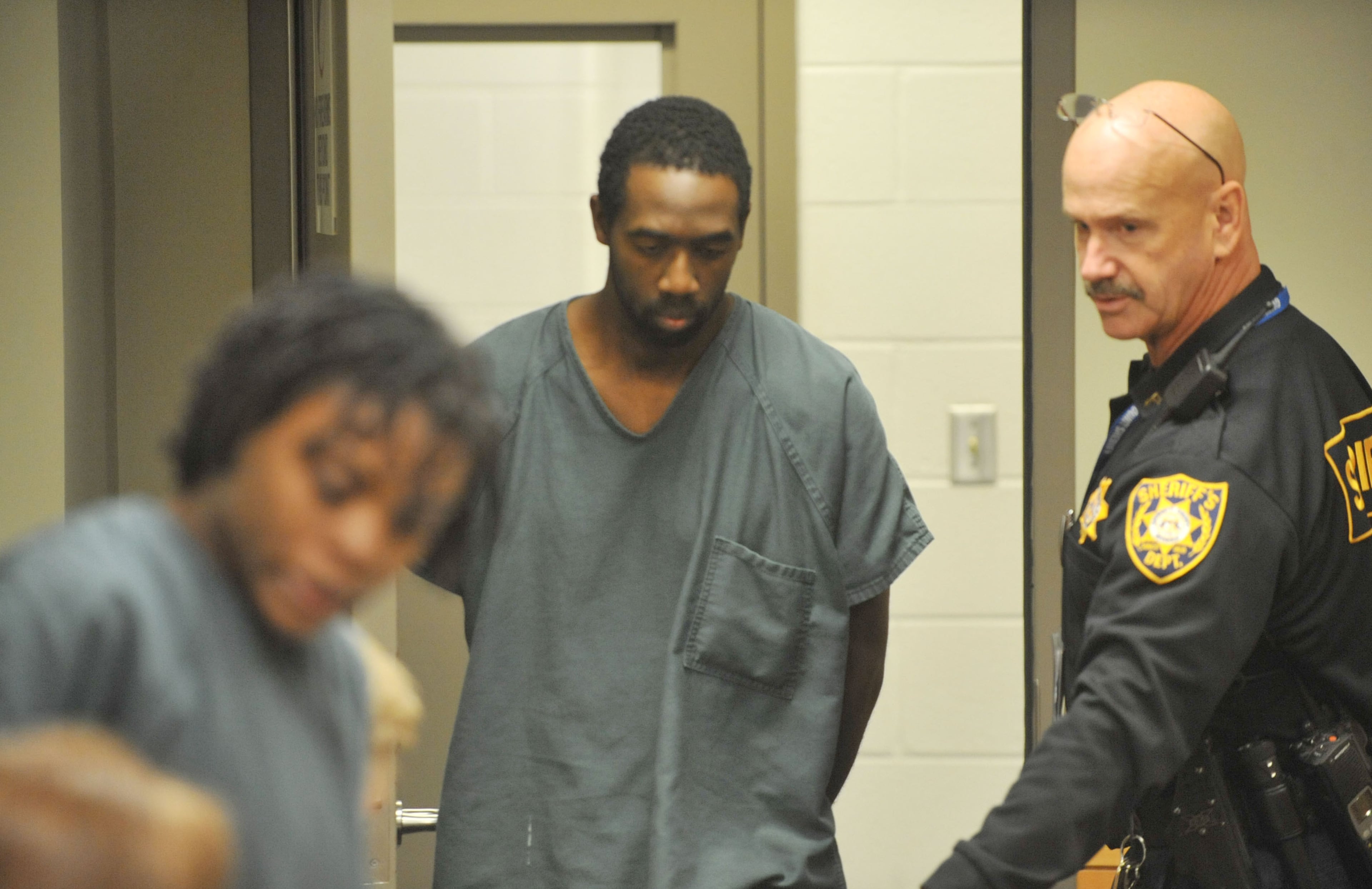 Eman Moss enters Magistrate Court Friday afternoon. The parents of Emani Moss are shown during their first court appearance before Gwinnett County Chief Magistrate Kristina Blum in Gwinnett County Magistrate Court Friday November 8, 2013. Eman and Tiffany Moss, of Lawrenceville, Georgia, have been arrested and charged with murder, concealing a body, and child cruelty after police say they had starved to death their daughter, Emani, and then set her body on fire to cover up the crime.