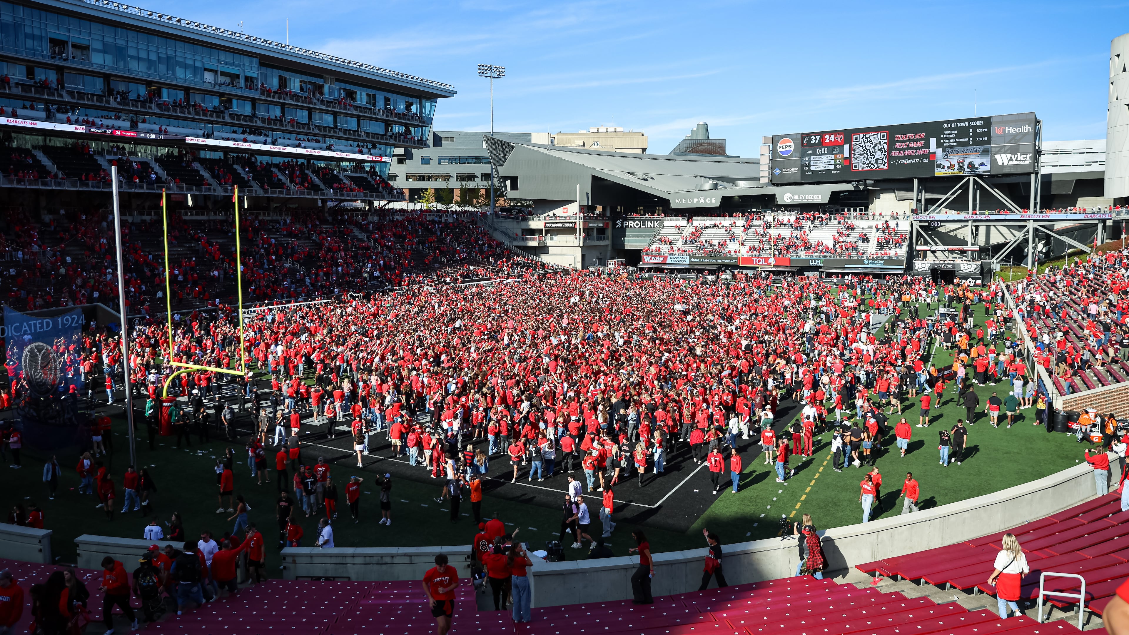 University of Cincinnati fans storm the field after an NCAA college football game against Texas Tech, Saturday, Oct. 24 2026, in Cincinnati. (AP Photo/Lydia Schembre)