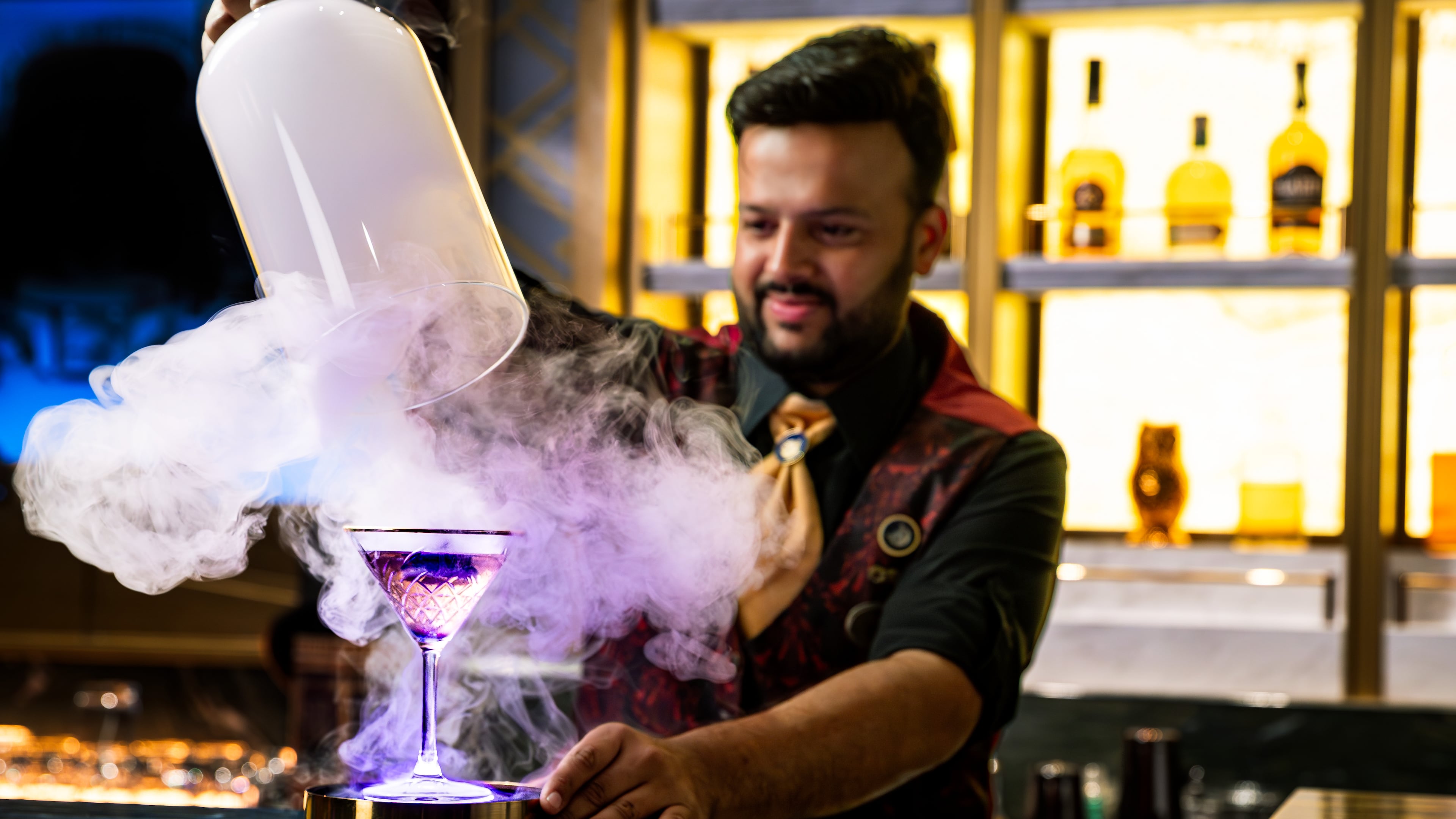 A bartender unveils a smoke-filled cocktail at Spellbound, where theatrical presentations are part of the immersive cocktail experience aboard the Star Princess. (Courtesy of Princess Cruises)