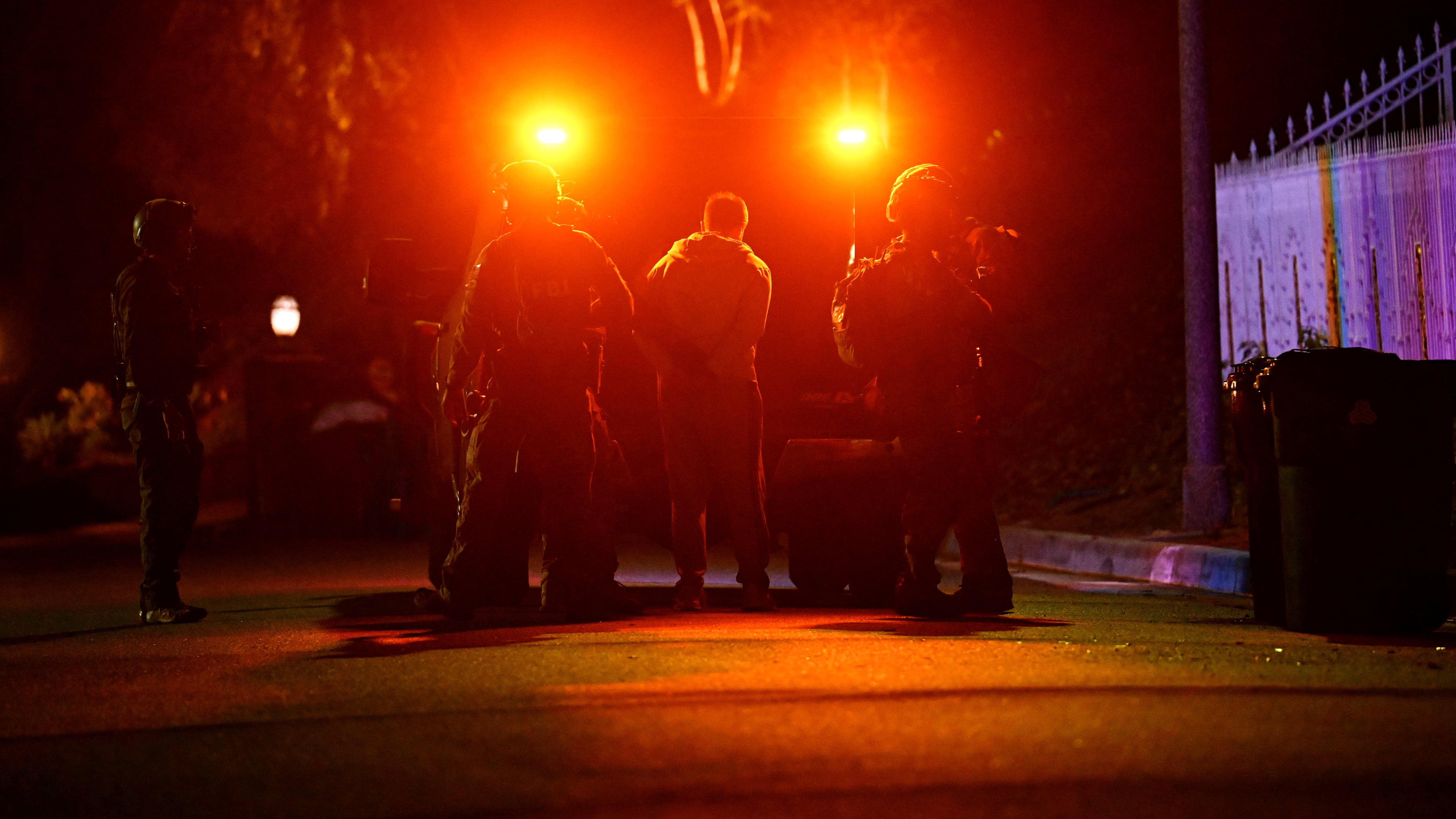 Federal agents arrest a suspect during a raid related to health care fraud in the early morning on Thursday, Oct. 22, 2026, in Los Angeles. (AP Photo/Wally Skalij)