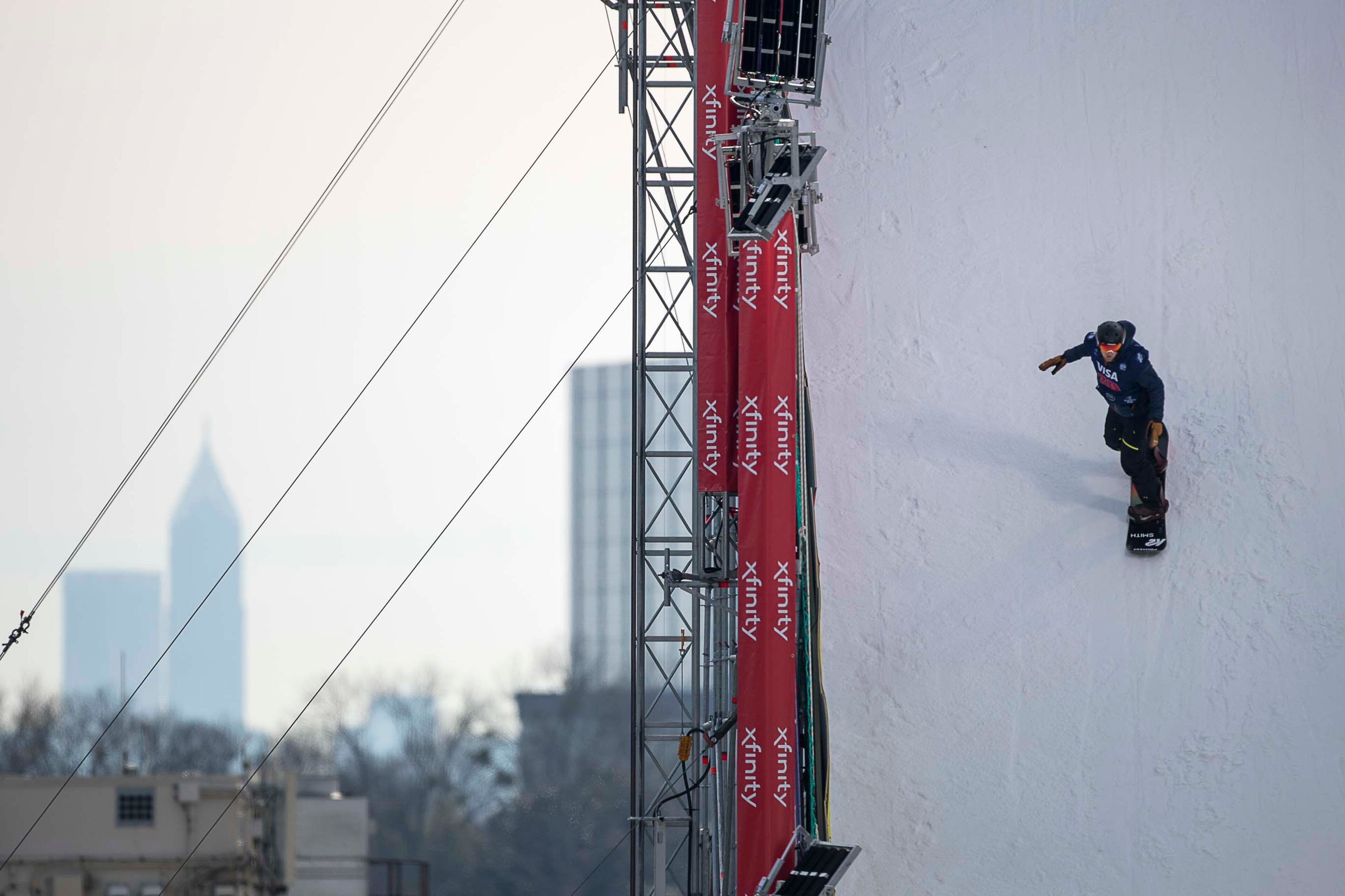 Snowboarder Enzo Valax gains momentum while coming down the slope as he practices before the men's qualification round during the Visa City Big Air FIS Snowboard World Cup at SunTrust Park in Atlanta on Friday, December 20, 2019. (ALYSSA POINTER/ALYSSA.POINTER@AJC.COM)