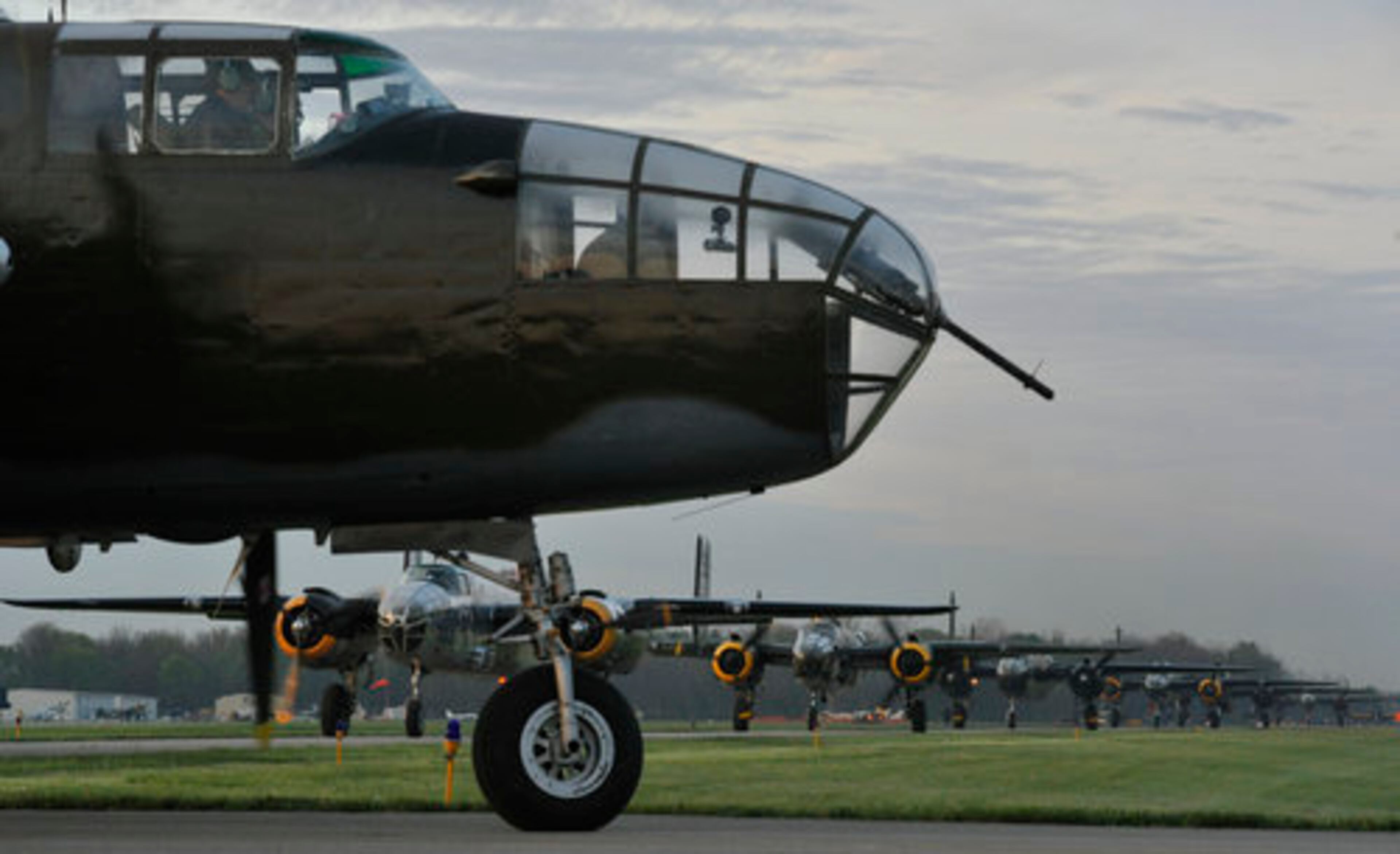 Twenty vintage B-25 bombers line up for take off at Grimes Field in Urbana Tuesday morning as they depart for Wright Patterson Air Force Base for the Doolittle Raiders Reunion. The planes have been staging in Urbana throughout the weekend so they could all fly into the reunion together. It is the largest gathering of the planes since WWII.