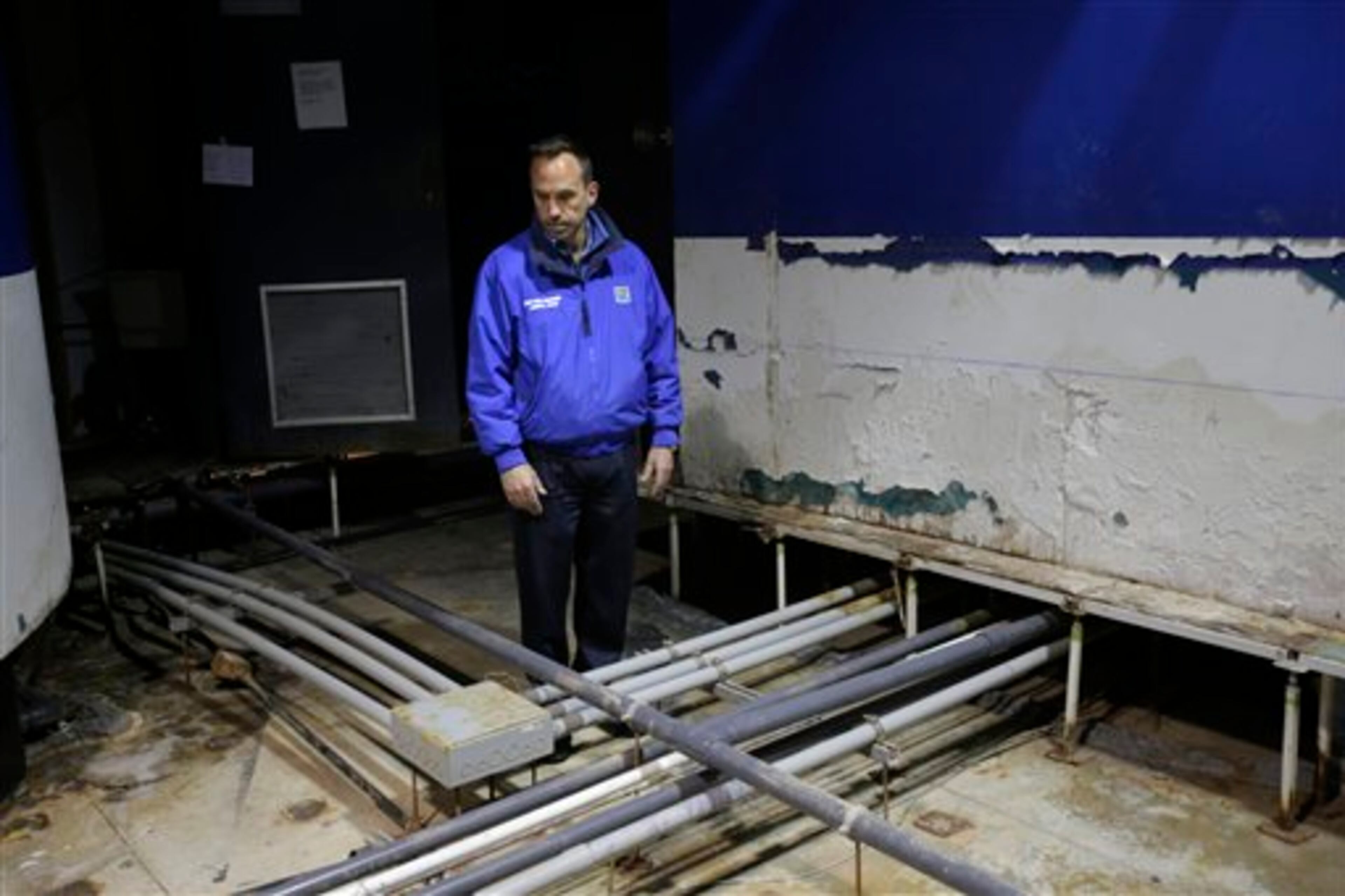 Director of the New York Aquarium, John Dohlin, looks around an exhibit ruined during Superstorm Sandy at the aquarium in Coney Island, New York, Monday, March 25, 2013. (AP Photo/Seth Wenig)