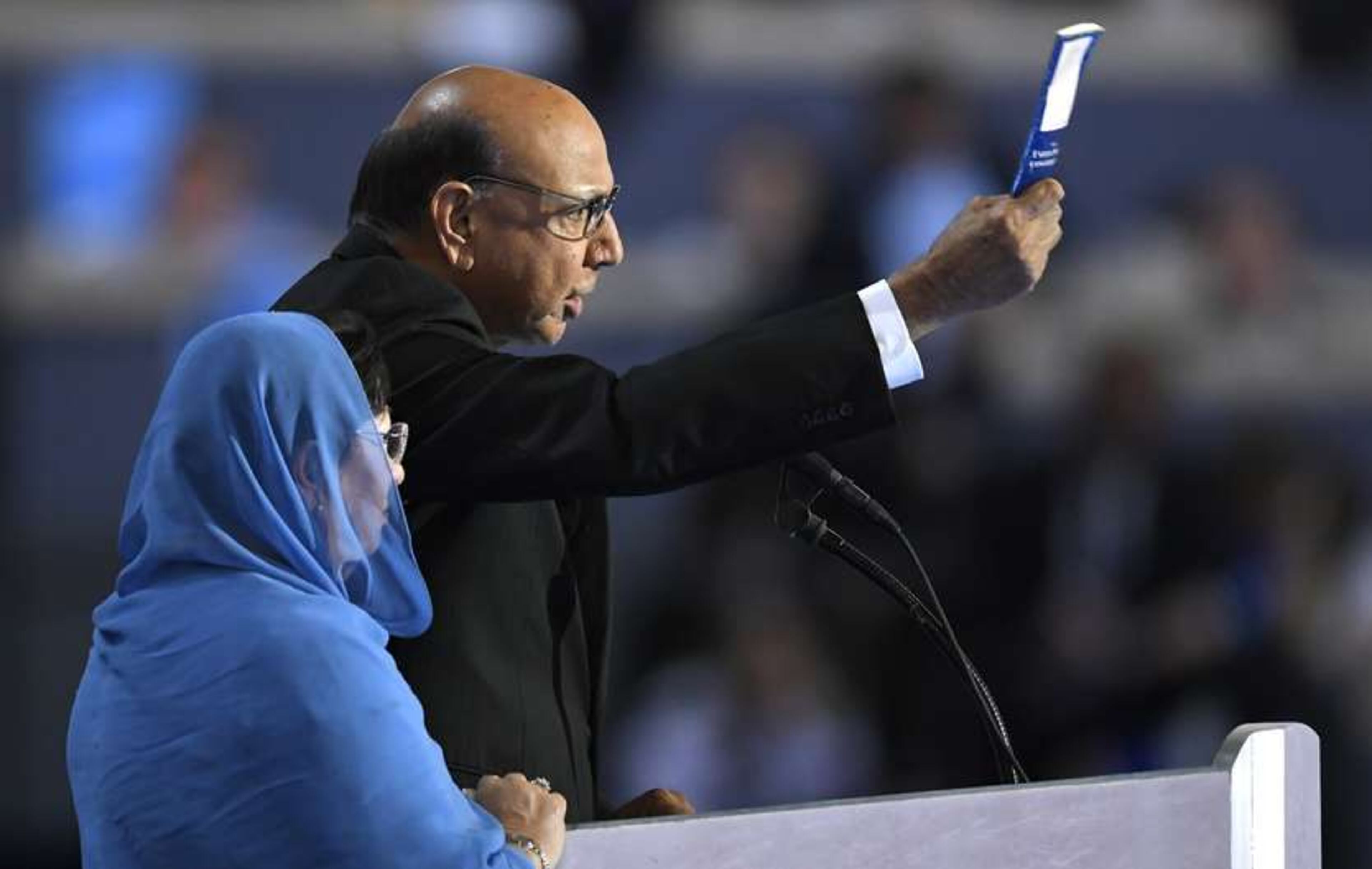 Khizr Khan, father of fallen US Army Capt. Humayun S. M. Khan, holds up his copy the United State Constitution as he speaks during the final day of the Democratic National Convention in Philadelphia, Thursday, July 28, 2016. (AP Photo/Mark J. Terrill)