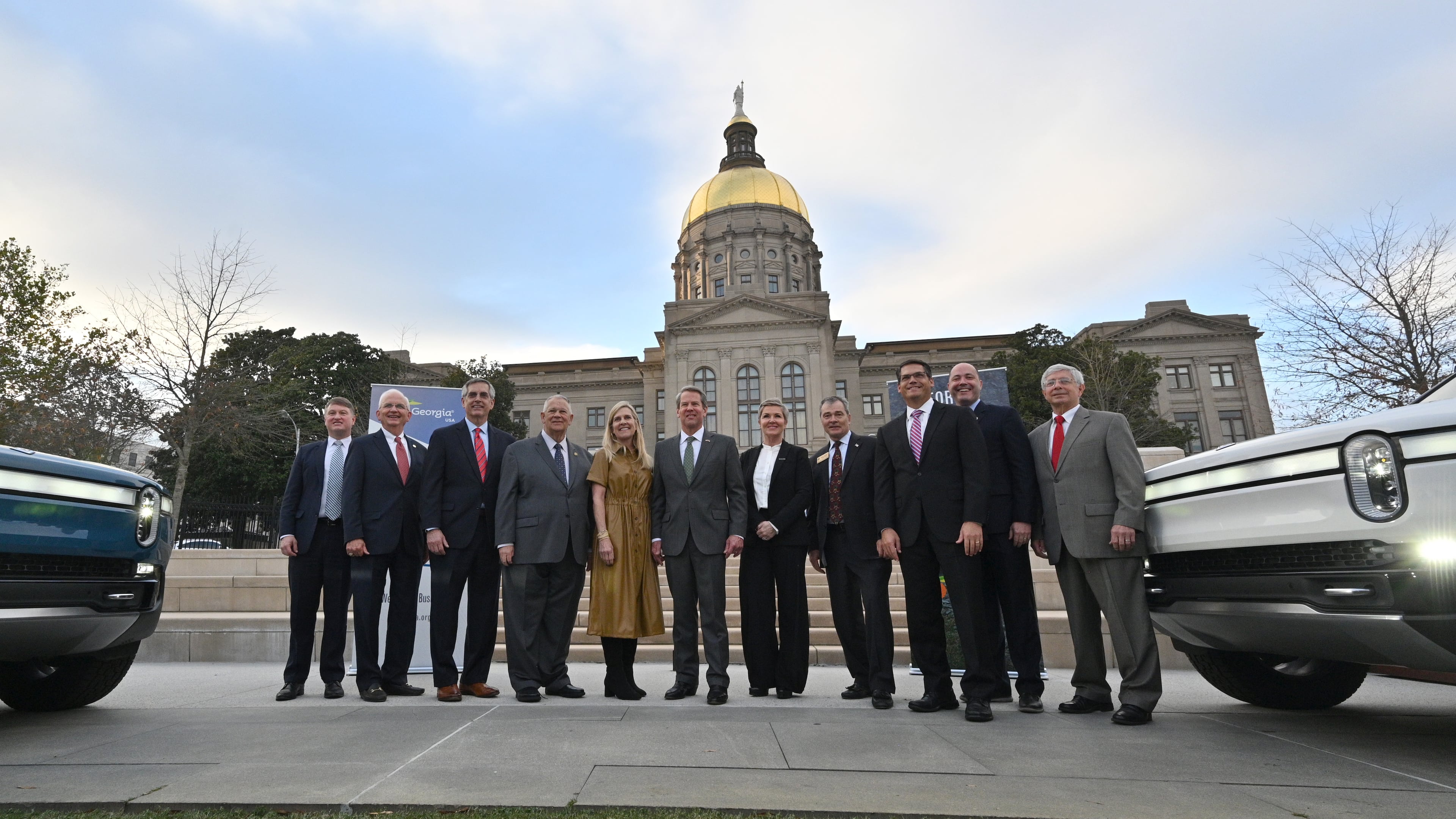 December 16, 2021 Atlanta - Governor Brian Kemp (center) and Georgia lawmakers pose with Helen Russell, Chief People Officer at Rivian, during a press conference at Liberty Plaza across from the Georgia State Capitol in Atlanta on Thursday, December 16, 2021. Electric vehicle maker Rivian on Thursday confirmed its plans to build a $5 billion assembly plant and battery factory in Georgia, which Gov. Brian Kemp called Òthe largest single economic development project ever in this stateÕs history.Ó (Hyosub Shin / Hyosub.Shin@ajc.com)