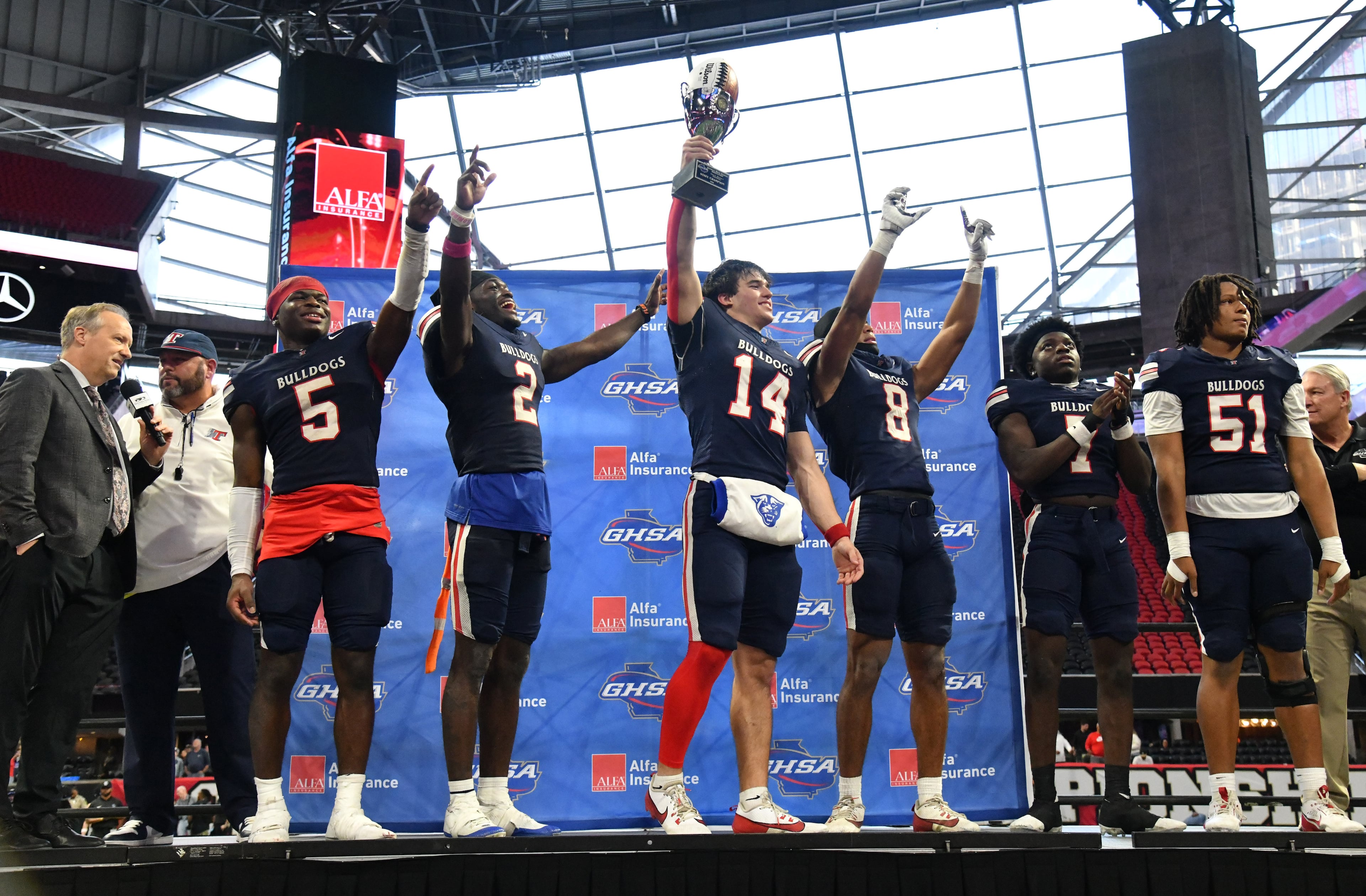 Toombs County coach Buddy Martin and players celebrate their victory over Northeast Macon in GHSA Class A-Division State Championship game at Mercedes-Benz Stadium, Tuesday, December 17, 2024, in Atlanta. Toombs County won 38-18 over Northeast Macon. (Hyosub Shin / AJC)