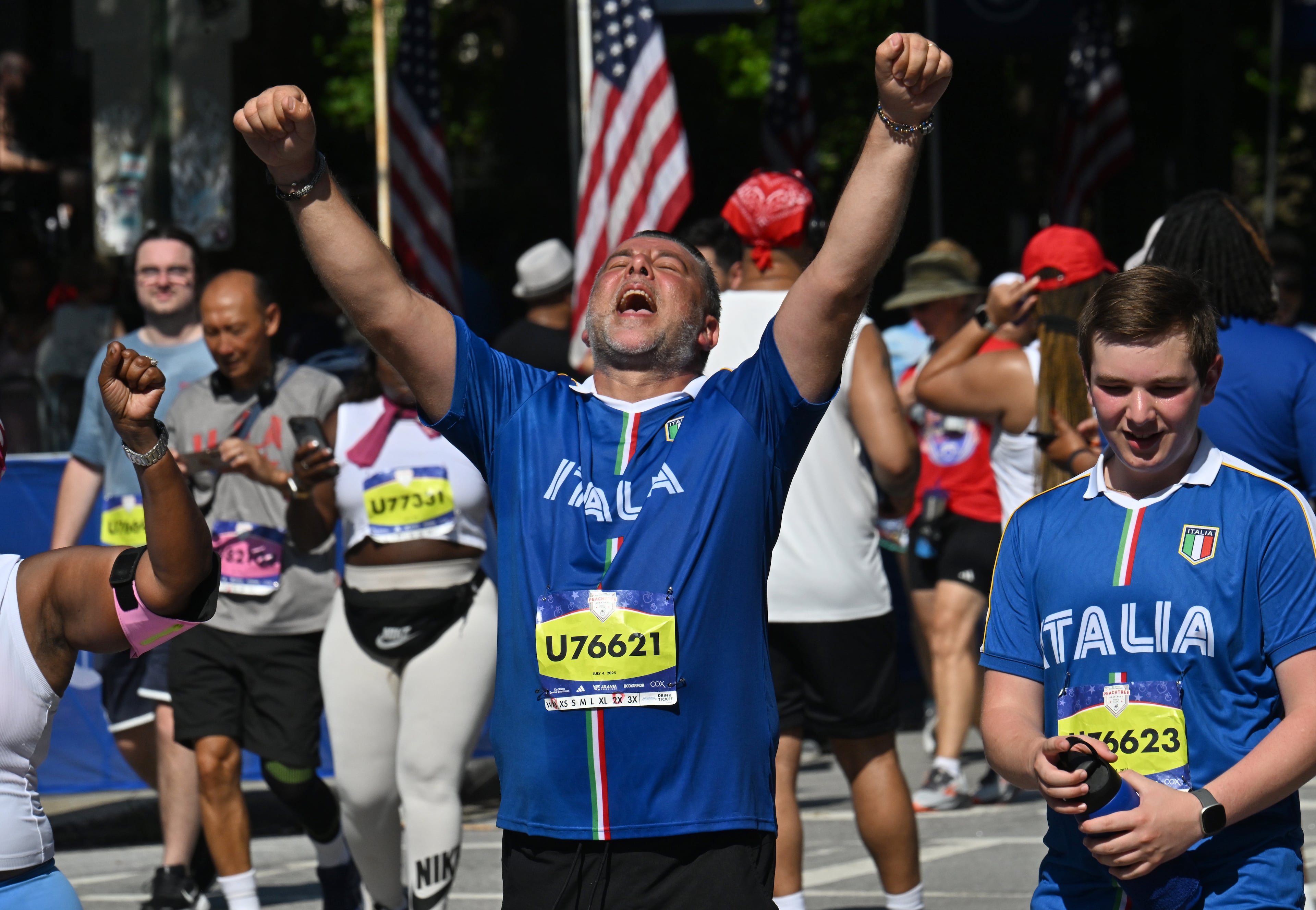 Runners celebrate as they cross the finish line of the 56th running of the Peachtree Road Race. It's the feeling I'm chasing over the next two weeks of training. (Hyosub Shin/AJC)