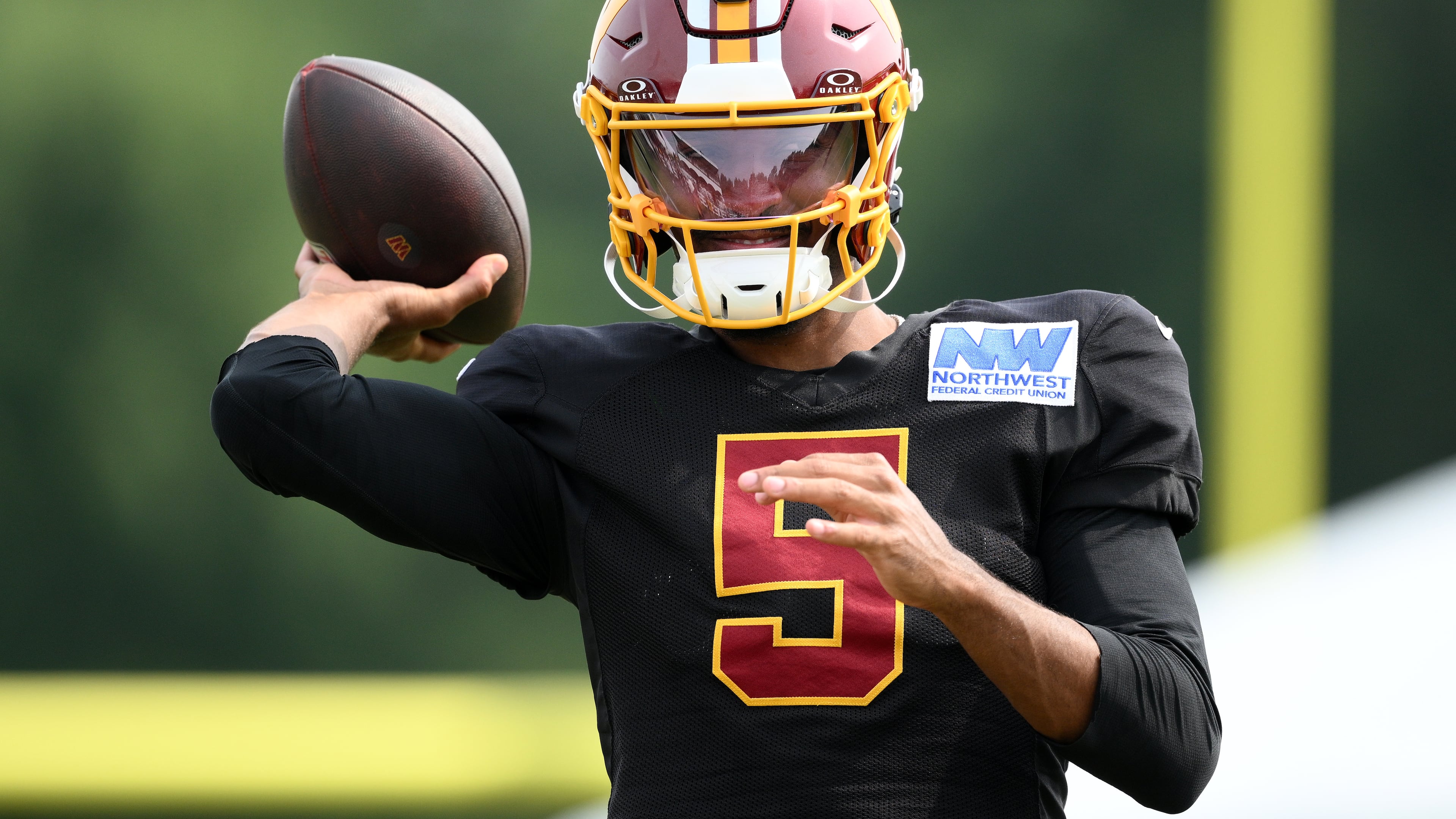 Washington Commanders quarterback Jayden Daniels works out before a joint practice with the Miami Dolphins at NFL football training camp, Wednesday, Aug. 12, 2026 in Ashburn, Va. (AP Photo/Nick Wass)
