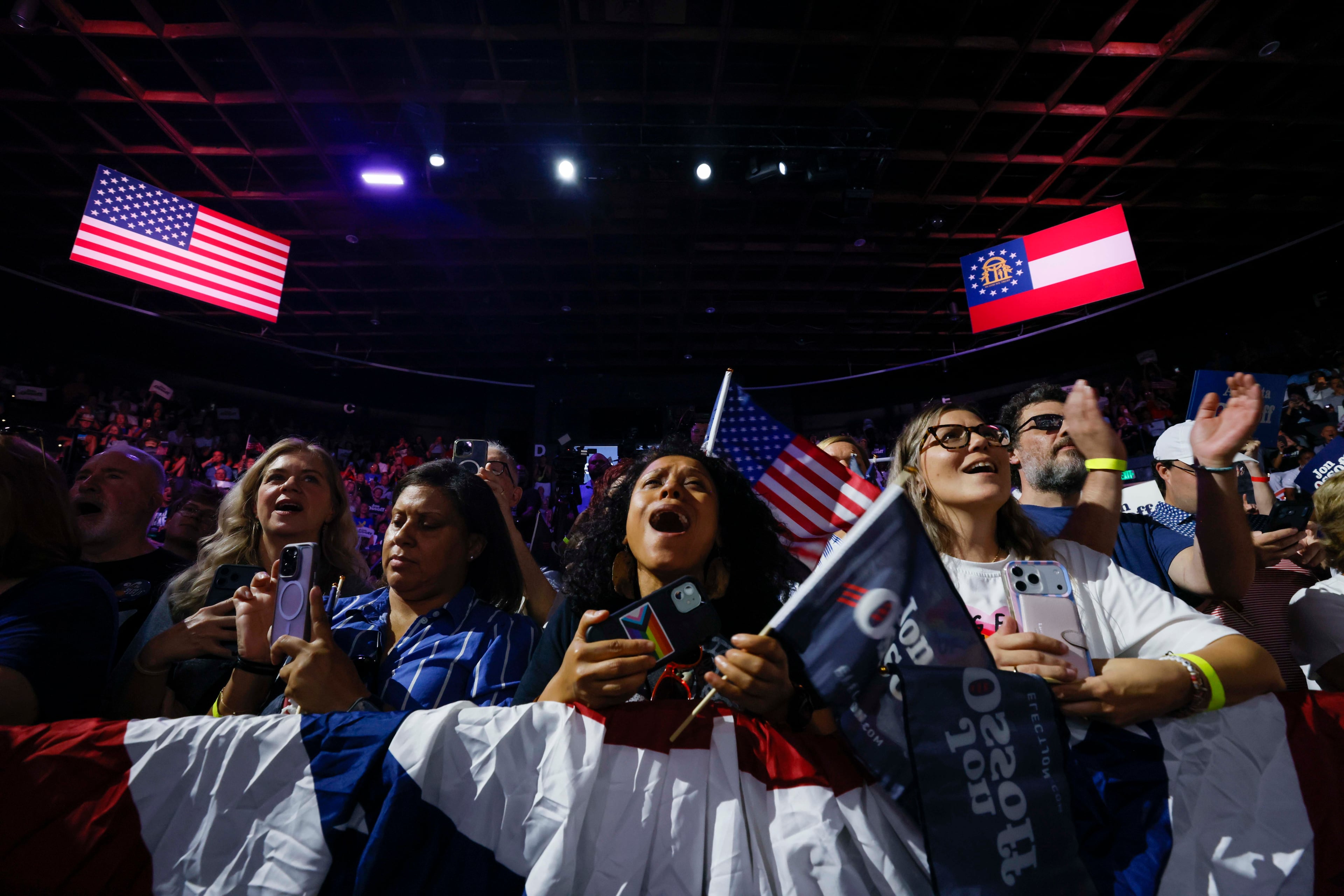 Supporters of U.S. Sen. Jon Ossoff, including Michelle Brittingham (right), react at the start of his speech at his campaign rally at the Center Stage Theater on Sunday. (Miguel Martinez/AJC)