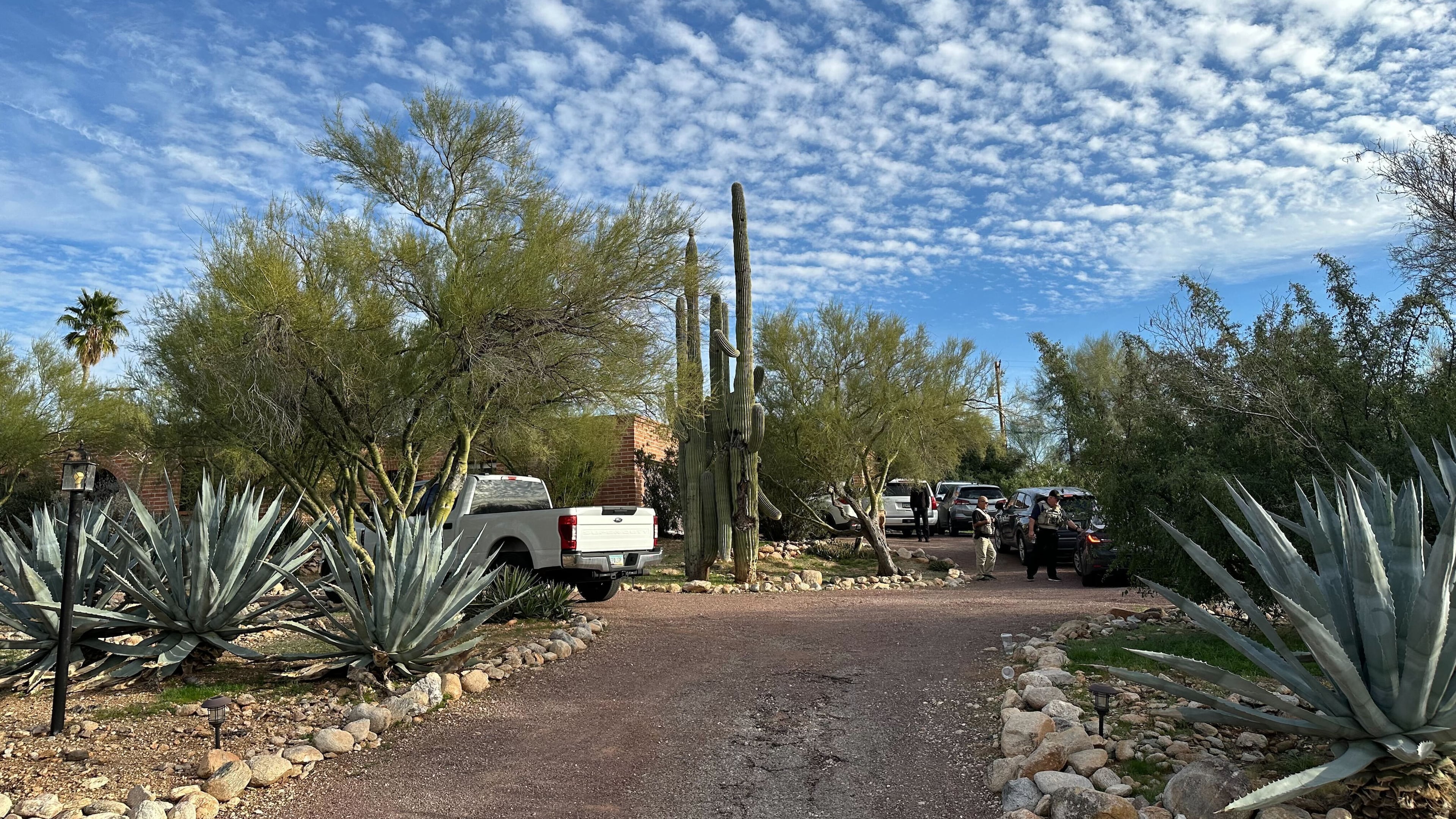 Law enforcement officers are present outside the home of Nancy Guthrie, the mother of "Today" host Savannah Guthrie, near Tucson, Ariz., Monday, Feb. 2, 2026. (AP Photo/Sejal Govindarao)