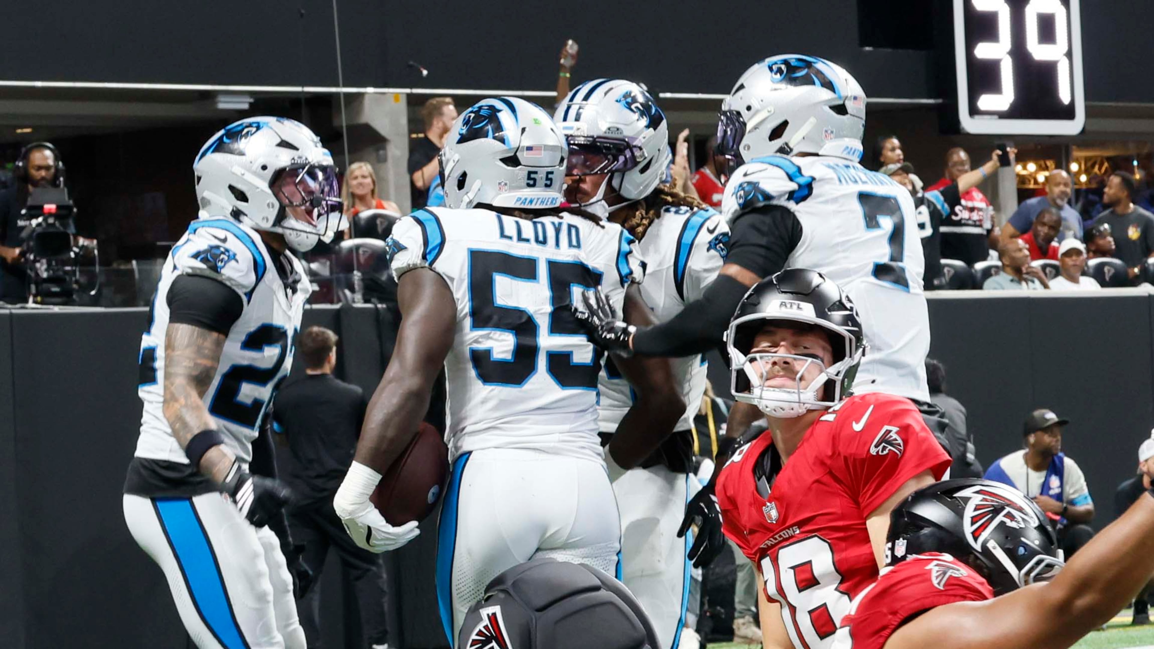 Atlanta Falcons quarterback Jack Strand (18), center, kneeling as the Carolina Panthers celebrate a touchdown after a fumble recovery during the second half of an NFL game at Mercedes-Benz Stadium in Atlanta on Sunday, Sept. 20, 2026. (Miguel Martinez/AJC)
