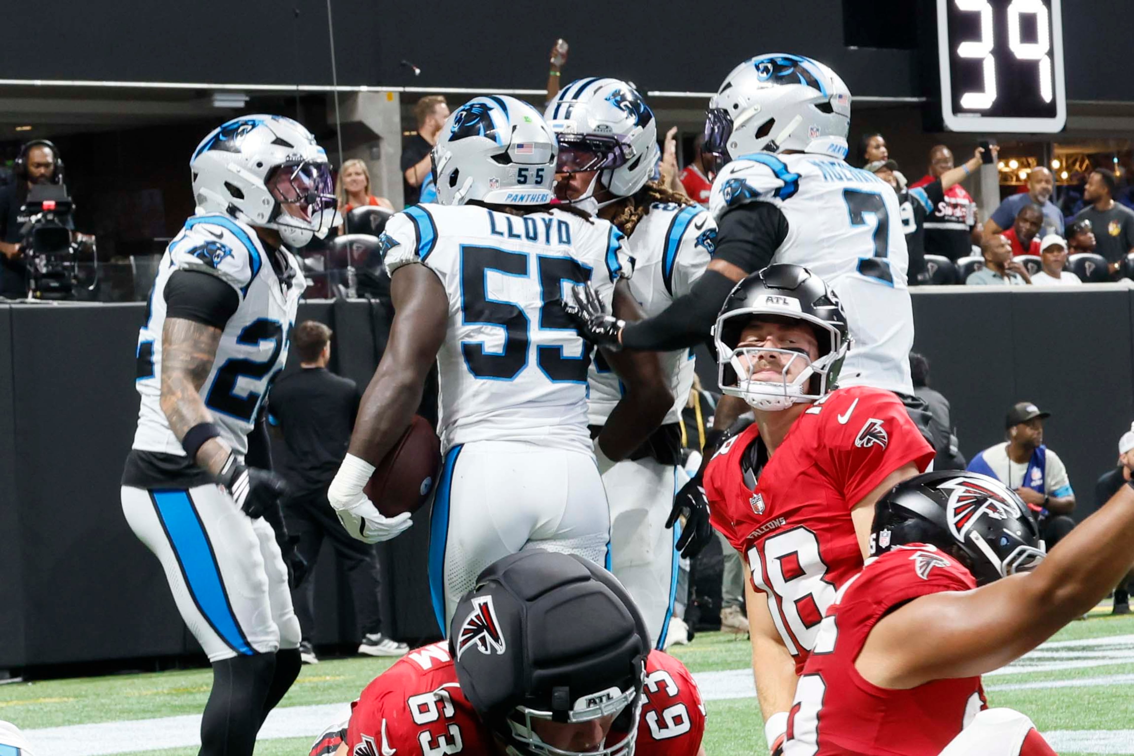 Atlanta Falcons quarterback Jack Strand (18), center, kneeling as the Carolina Panthers celebrate a touchdown after a fumble recovery during the second half of an NFL game at Mercedes-Benz Stadium in Atlanta on Sunday, Sept. 20, 2026. (Miguel Martinez/AJC)