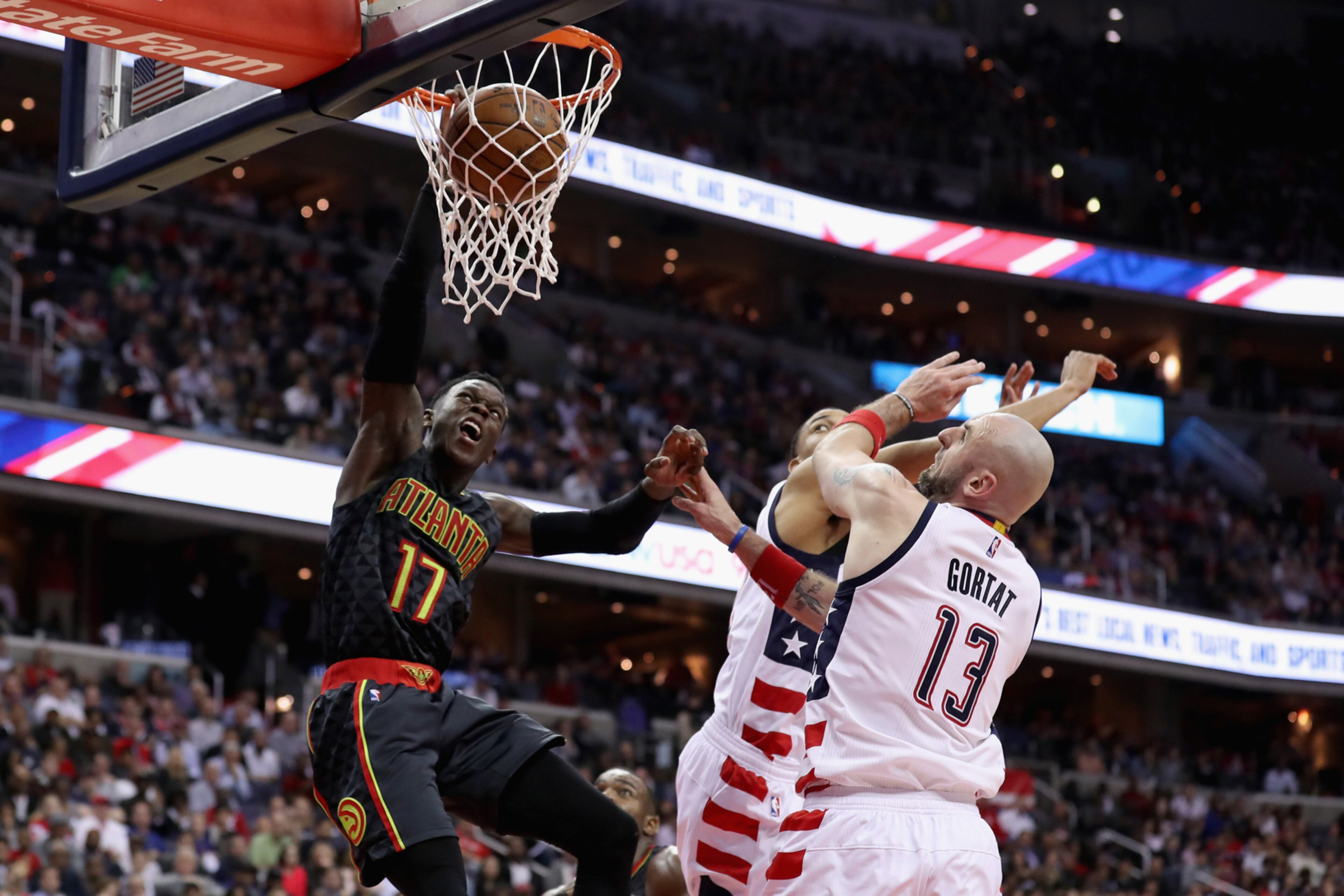 WASHINGTON, DC - APRIL 19: Dennis Schroder #17 of the Atlanta Hawks dunks the ball in front of Marcin Gortat #13 of the Washington Wizards in the second half in Game Two of the Eastern Conference Quarterfinals during the 2017 NBA Playoffs at Verizon Center on April 19, 2017 in Washington, DC. NOTE TO USER: User expressly acknowledges and agrees that, by downloading and or using this photograph, User is consenting to the terms and conditions of the Getty Images License Agreement. (Photo by Rob Carr/Getty Images)