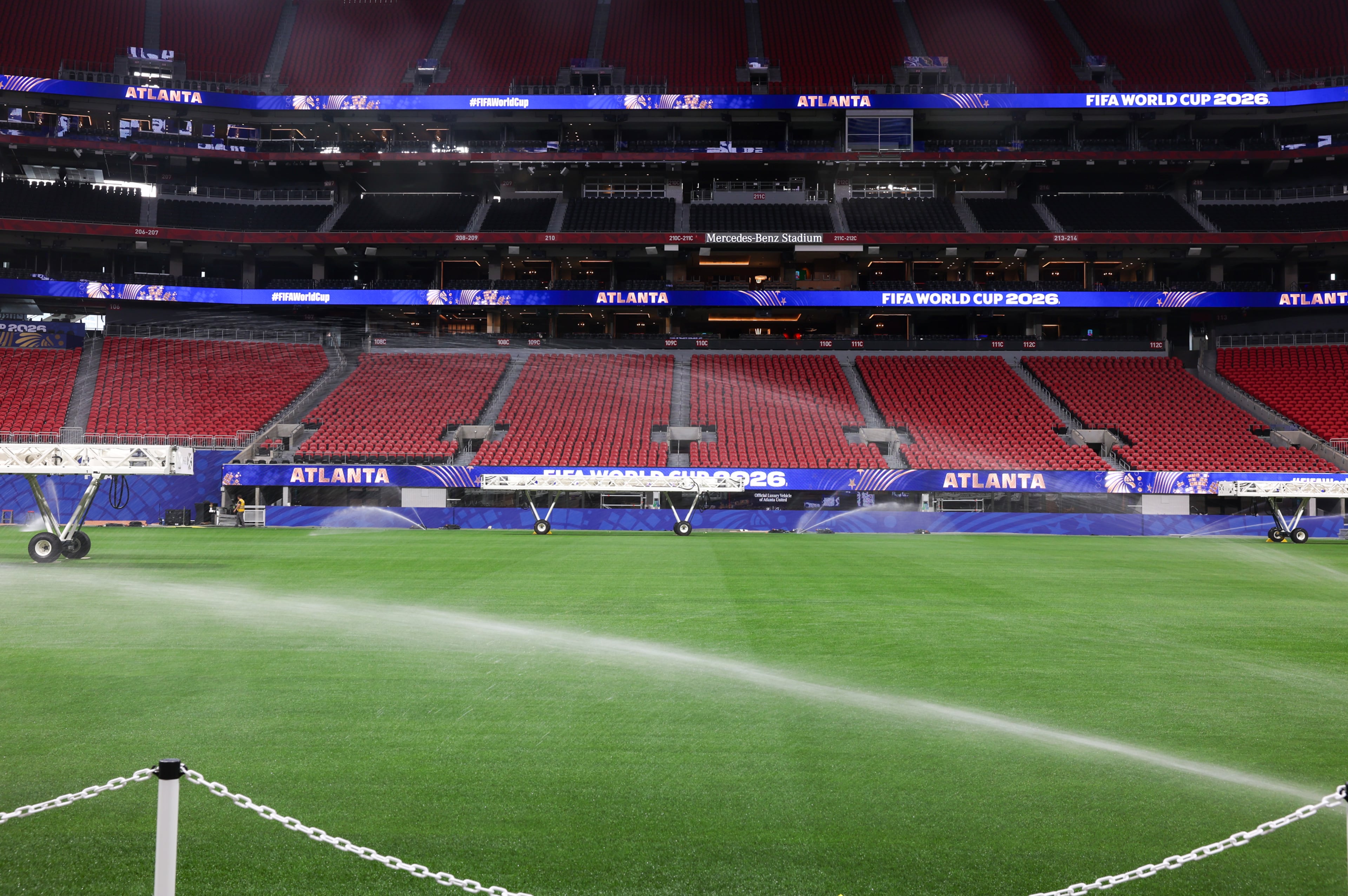 The newly installed playing surface for the FIFA World Cup is watered at the stadium in Atlanta on May 21, 2026. The pitch is Kentucky bluegrass mixed with perennial ryegrass with artificial fibers stitched in. It came from a turf farm in Colorado. (Arvin Temkar/AJC)