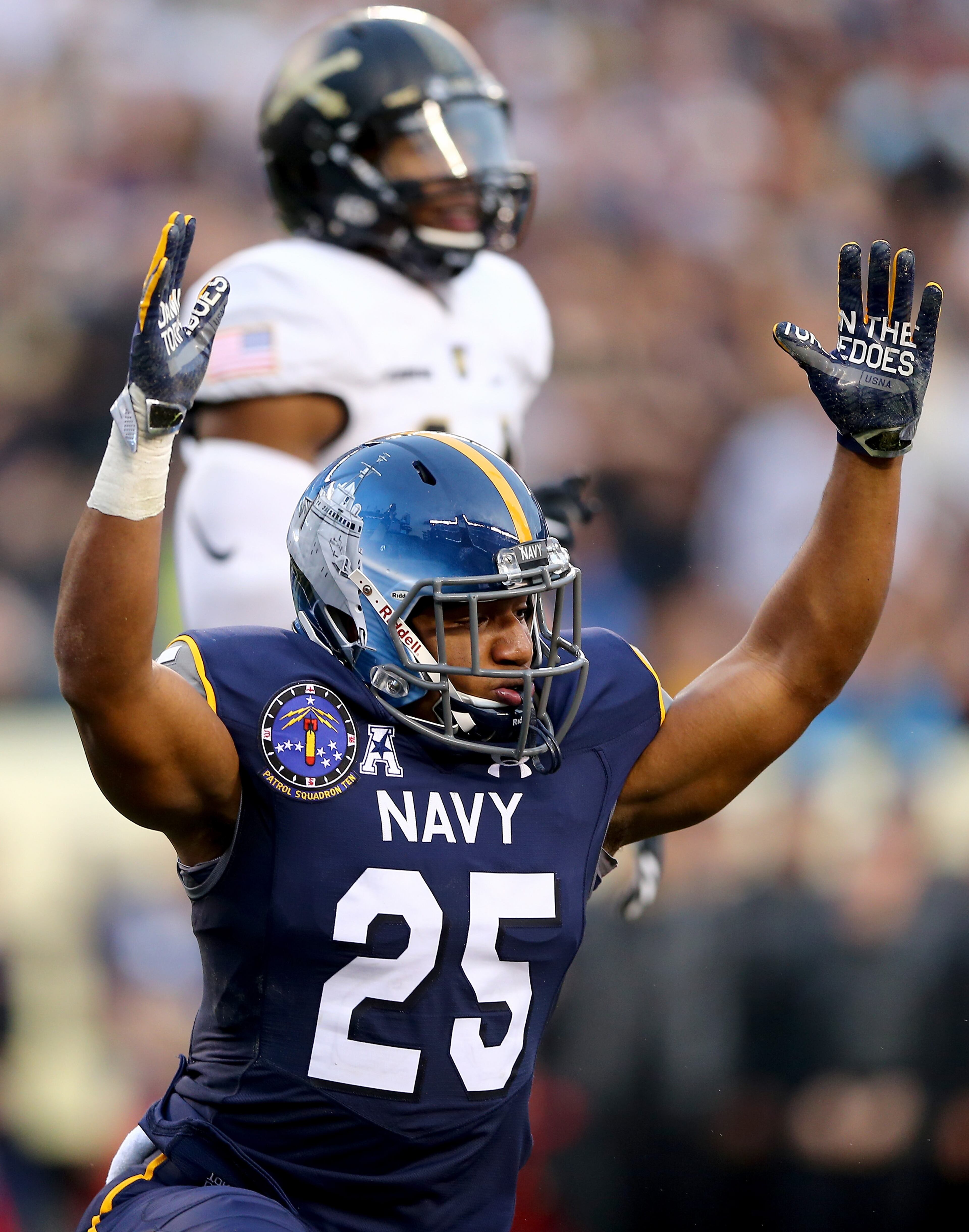 PHILADELPHIA, PA - DECEMBER 12: Desmond Brown #25 of the Navy Midshipmen celebrates teammate Keenan Reynolds touchdown in the second quarter against the Army Black Knights Lincoln Financial Field on December 12, 2015 in Philadelphia, Pennsylvania. (Photo by Elsa/Getty Images)