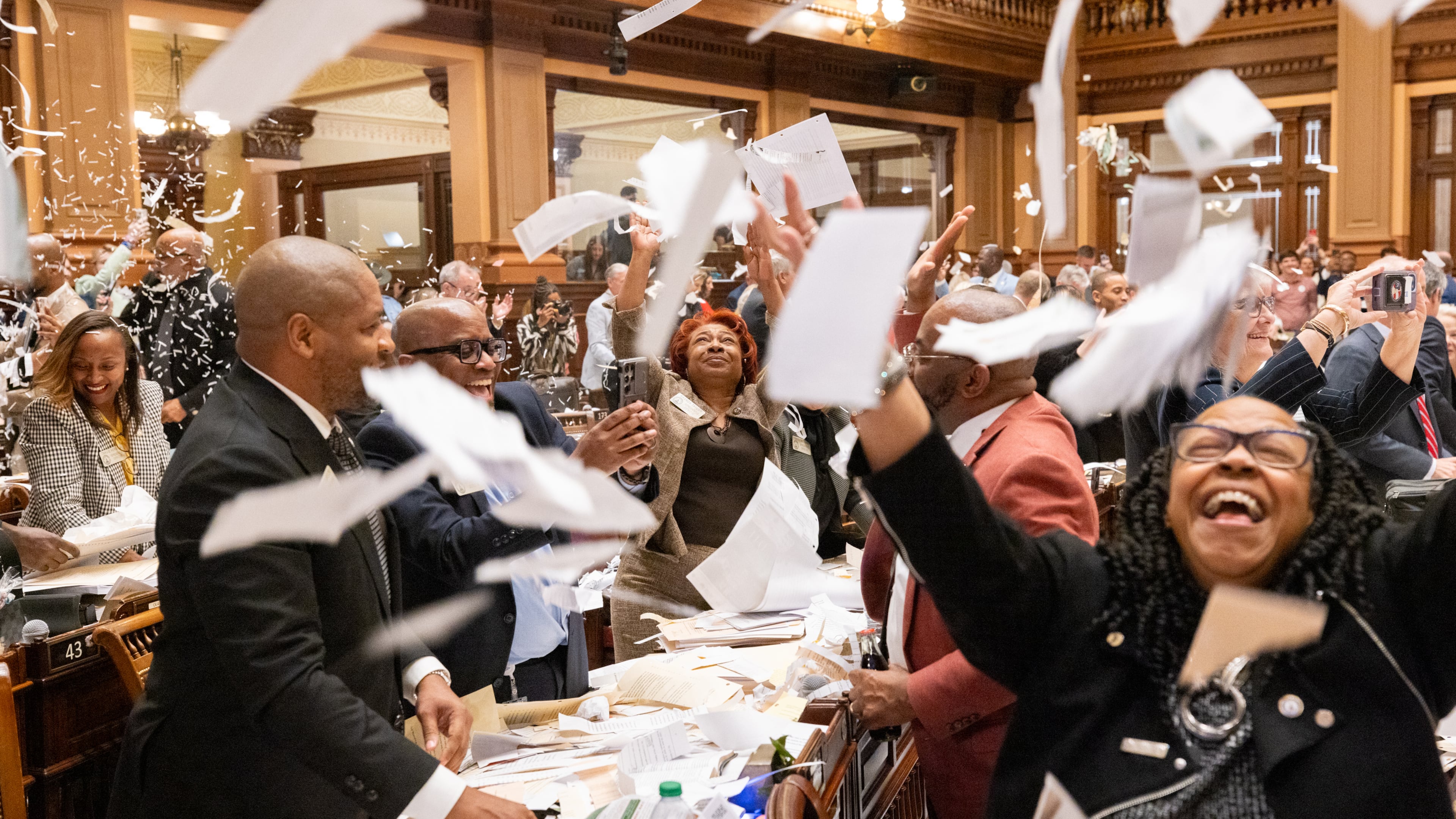 Georgia senators throw papers in the air as they adjourn the 2025 legislative session Friday night. Arvin Temkar / arvin.temkar@ajc.com