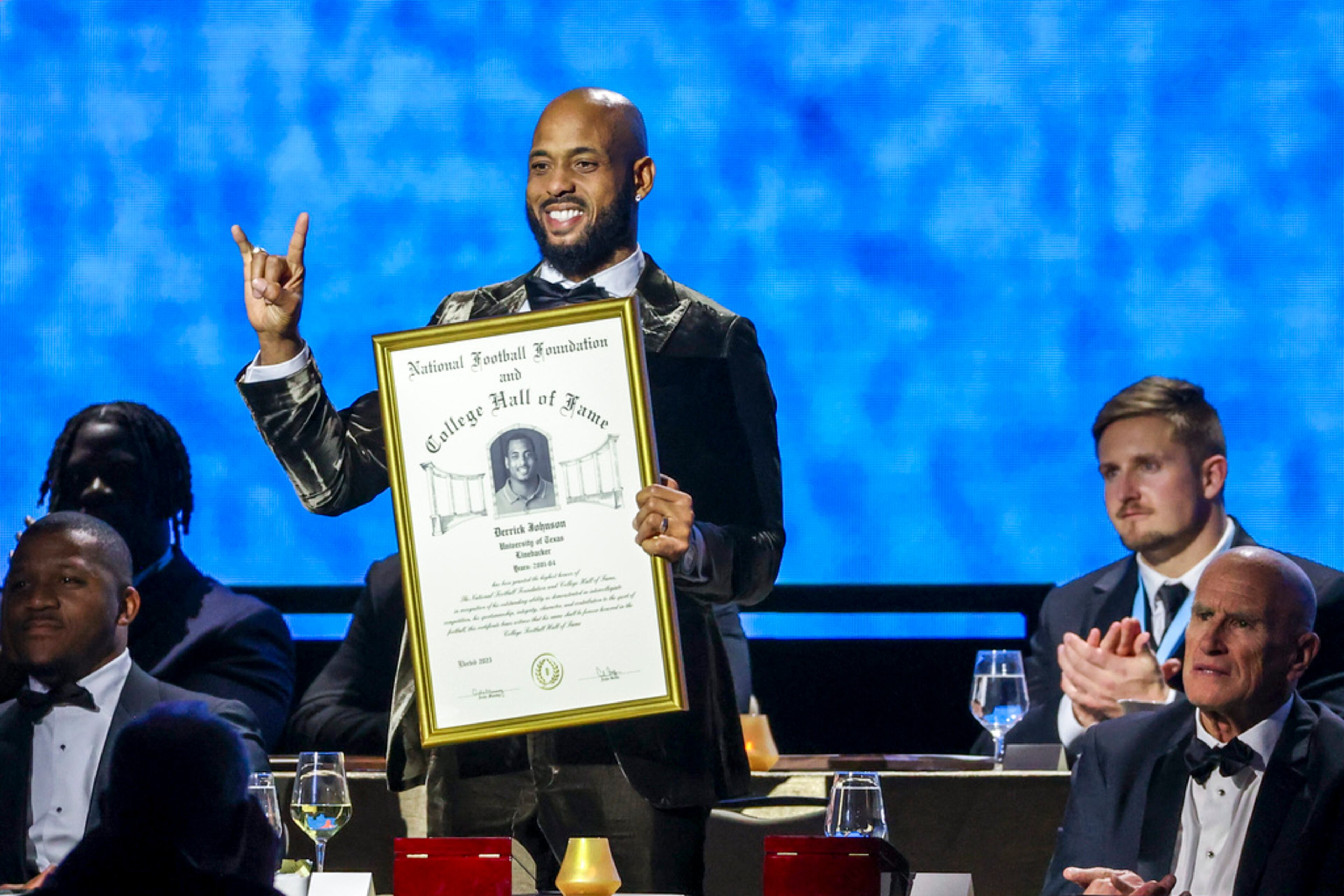Former Texas linebacker Derrick Johnson holds his College Football Hall of Fame Award during the National Football Foundation Awards Dinner, Tuesday, Dec. 5, 2023, in Las Vegas. (AP Photo/Ian Maule)