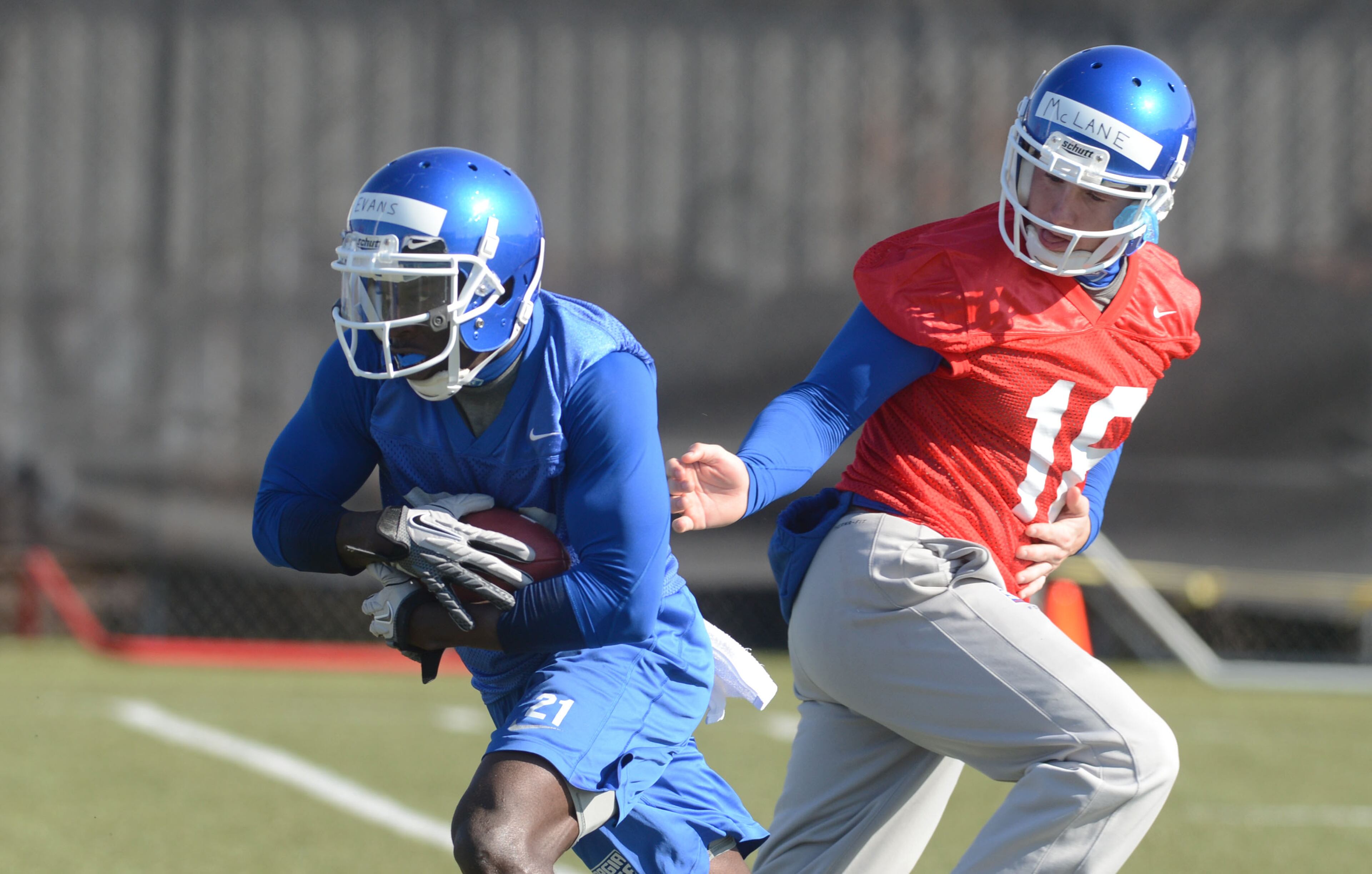 RB Travis Evans of Williston, FL takes the handoff from QB Ben McLane of Snellville during Weds practice. Georgia State opened its first spring practice under new head coach Trent Miles at the GSU Practice Complex in downtown Atlanta Wednesday, March 27, 2013. Wednesday's workout was the first of 15 practices that will culminate with the April 20 Spring Scrimmage, scheduled for 1 p.m. at the Georgia Dome.