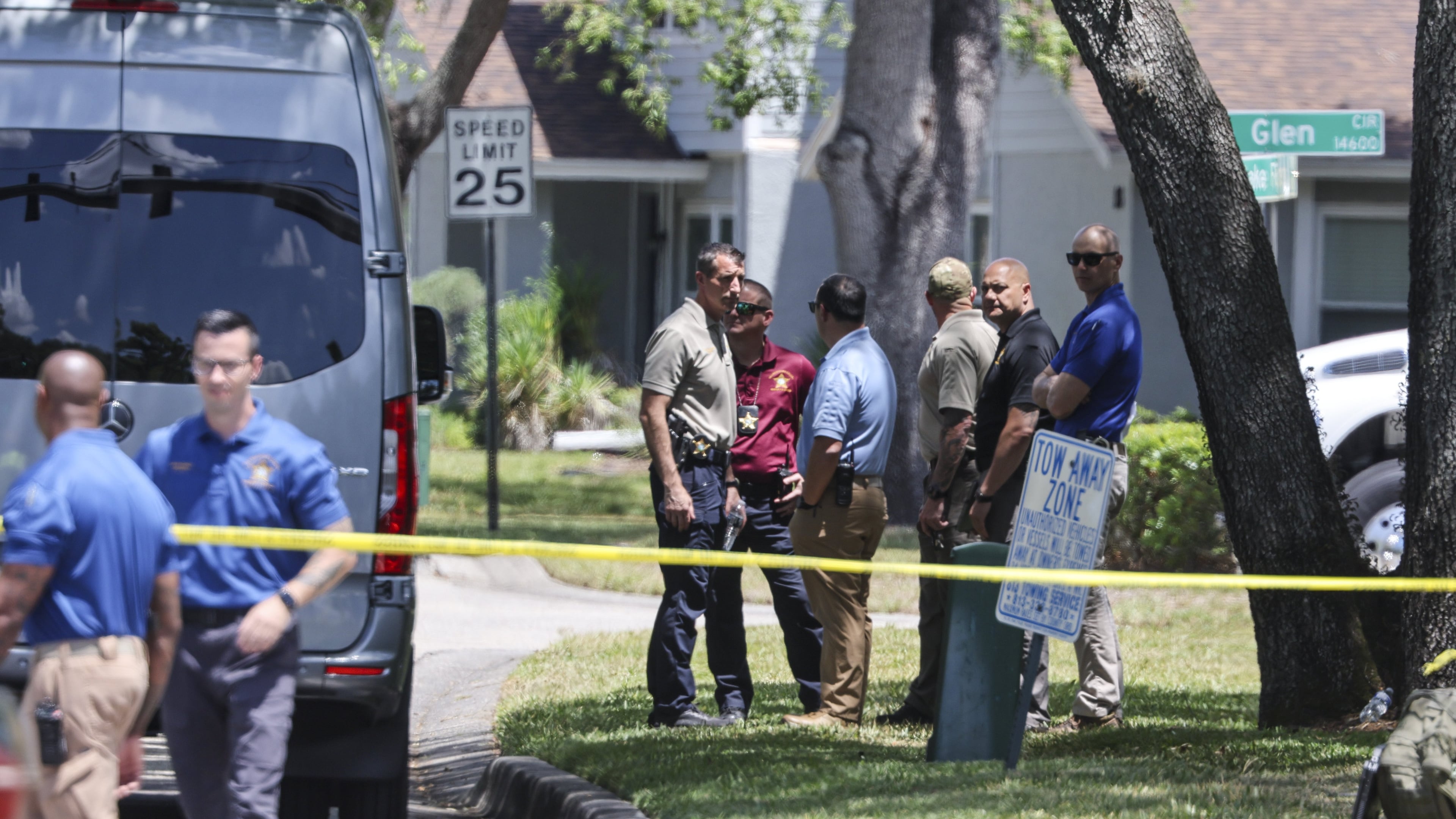 Detectives with the Hillsborough County Sheriff's Office join an investigation inside the Lake Forest subdivision of Tampa, Fla., on Friday, April 24, 2026, where authorities said a man was taken into custody after barricading himself inside a home, in connection to the search for two missing University of South Florida graduate students. (Douglas R. Clifford/Tampa Bay Times via AP)