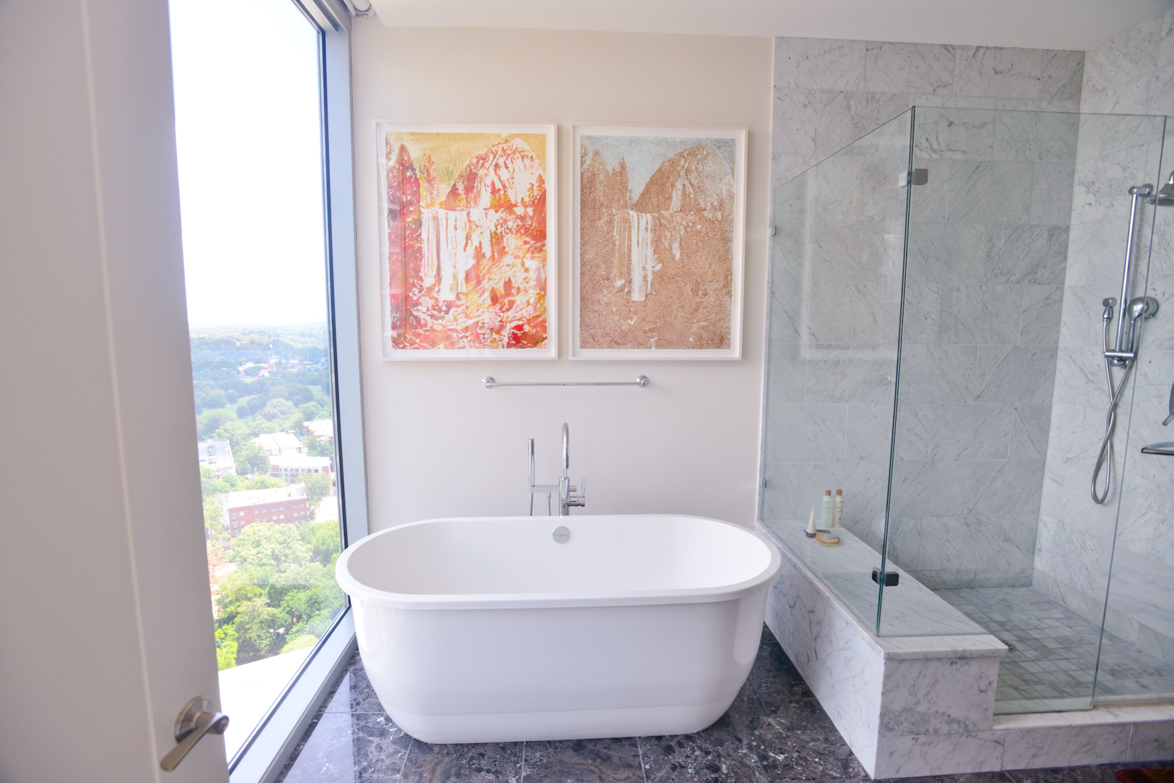 A standalone soaking tub, shades of gray and modern fixtures make this master bedroom a relaxing retreat 31 floors above the streets of Midtown Atlanta.