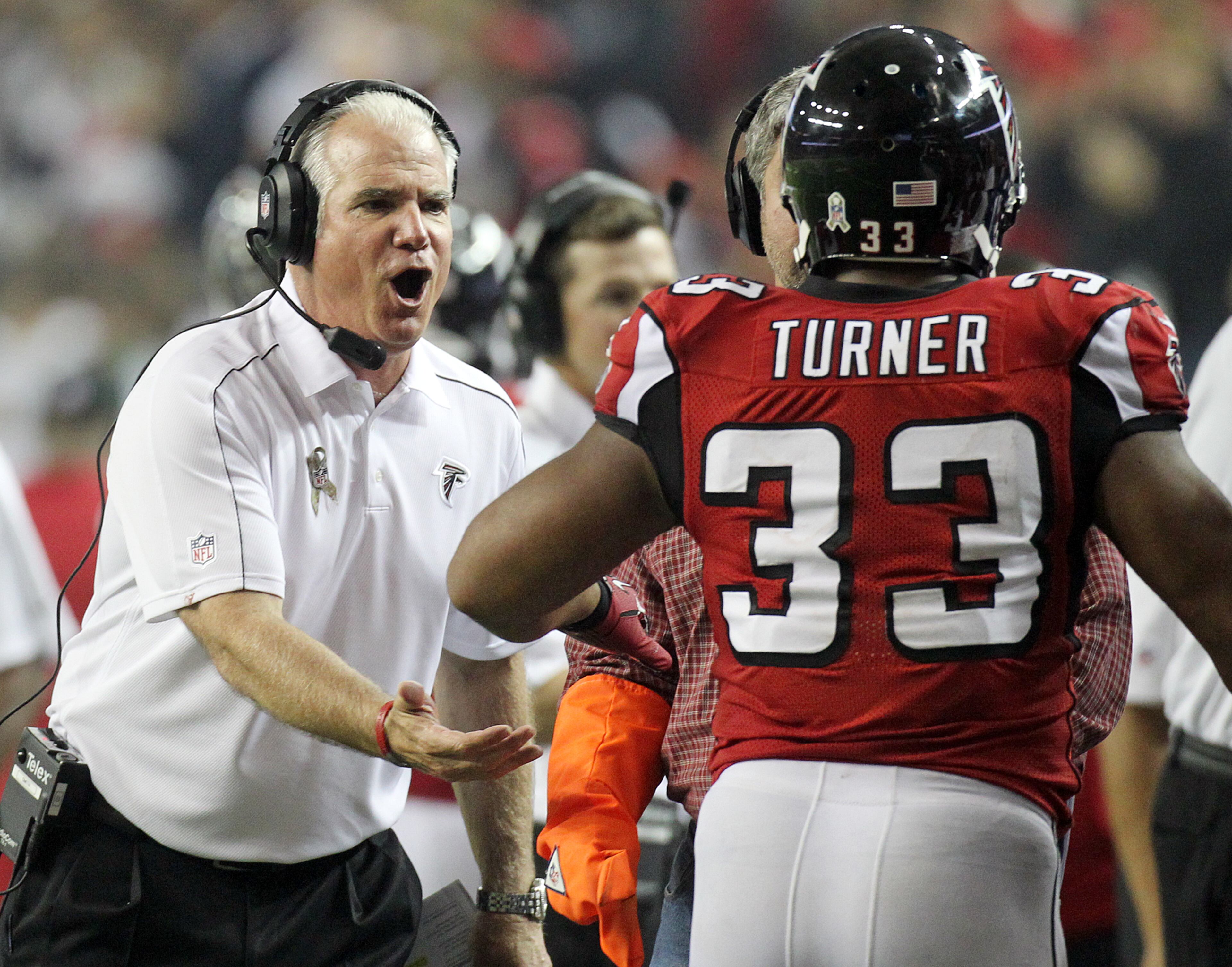 110412 ATLANTA: Falcons head coach Mike Smith greets running back Michael Turner on the sidelines after his fourth quarter touchdown run against the Cowboys at the Georgia Dome in Atlanta on Sunday, Nov. 4, 2012. CURTIS COMPTON / CCOMPTON@AJC.COM