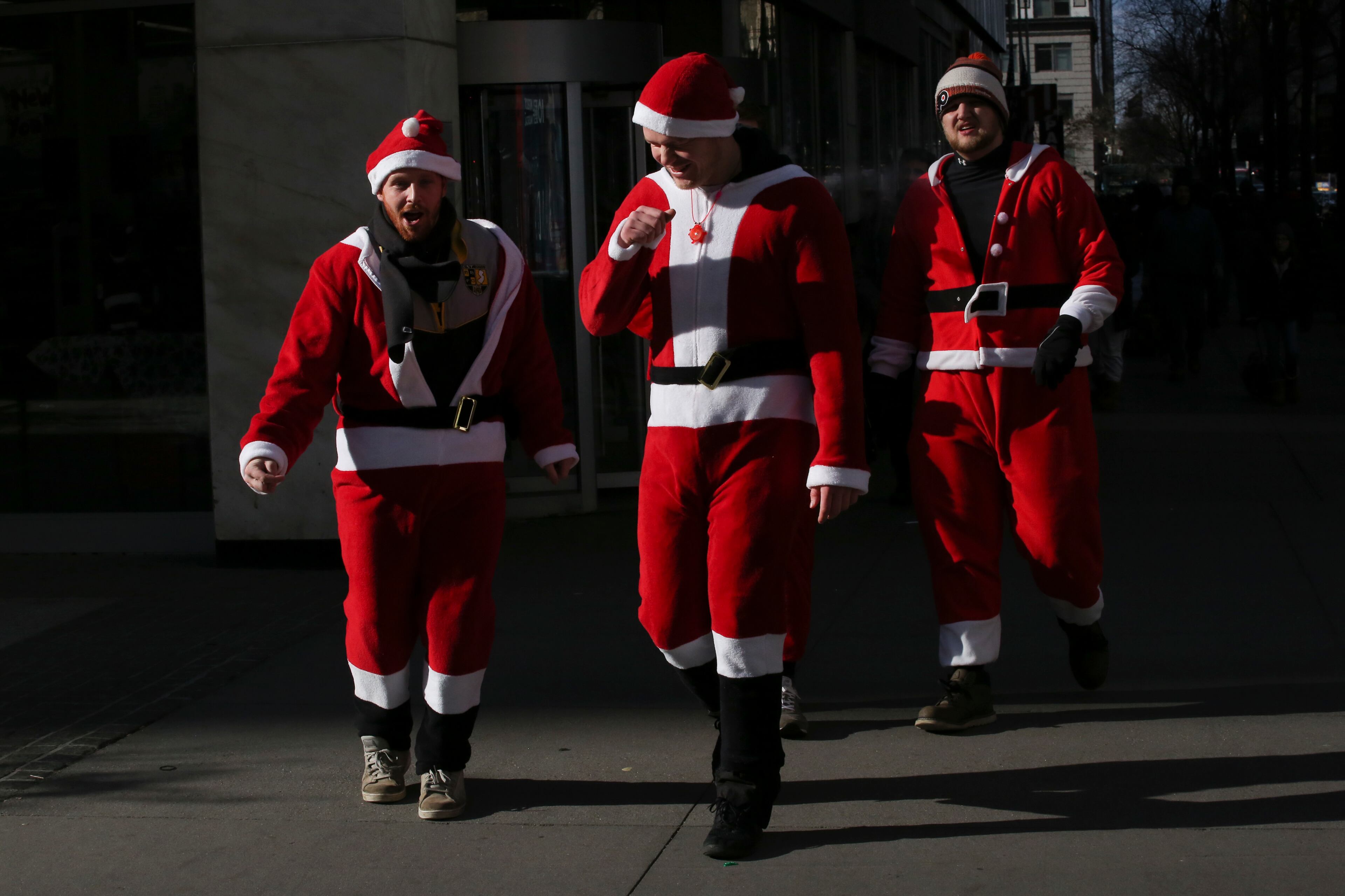 NEW YORK, NY - DECEMBER 08: People pass walk as they take part during the annual New York SantaCon on December 8, 2018 in New York City. SantaCon is in it's 20th year in New York City. (Photo by Kena Betancur/Getty Images)