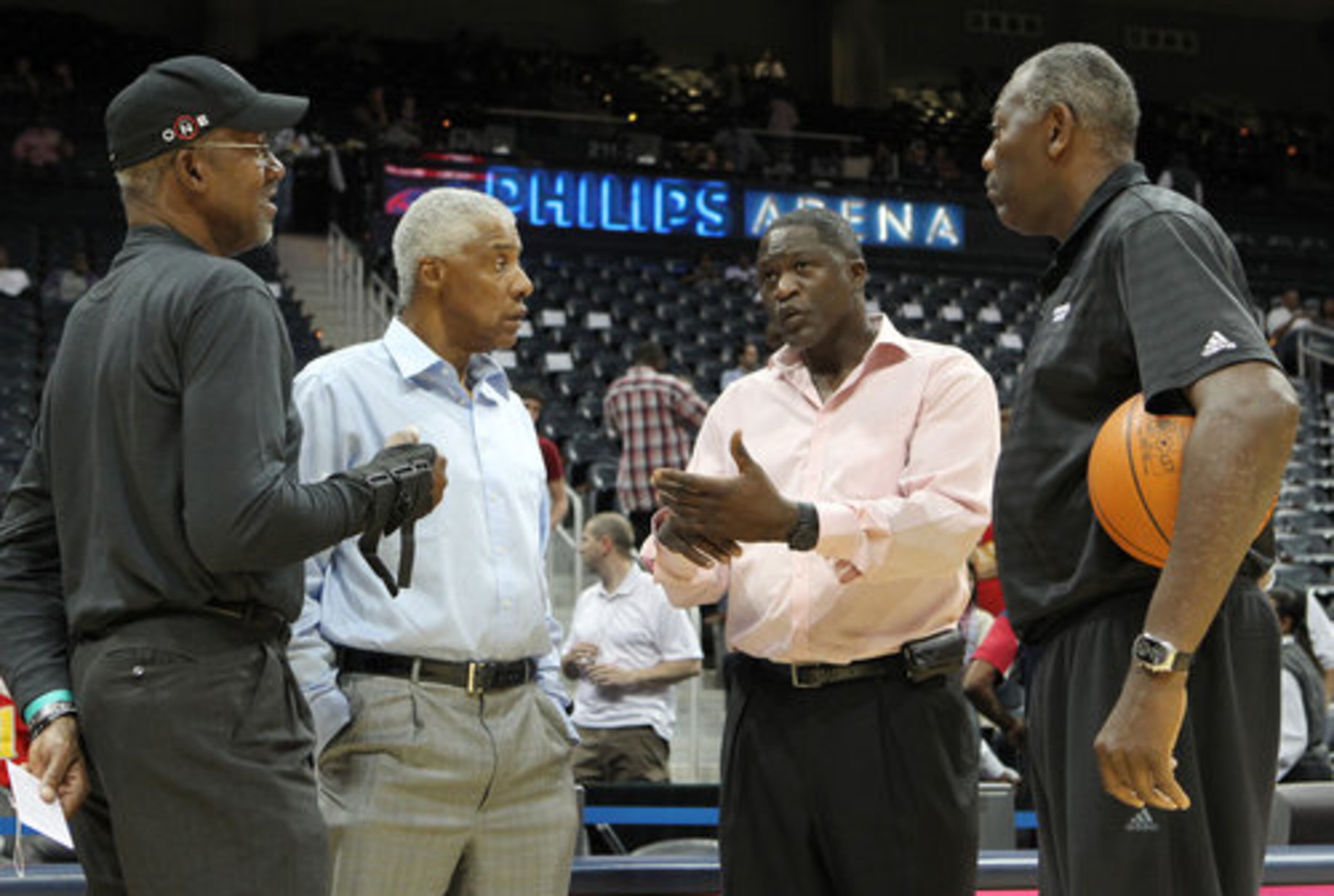 NBA greats Dan Roundfield, left to right, Julius Erving, Dominique Wilkins, and Bob McAdoo gather on the court to swap stories before the Atlanta Hawks play the Miami Heat at Philips Arena in Atlanta on Oct. 21, 2010.