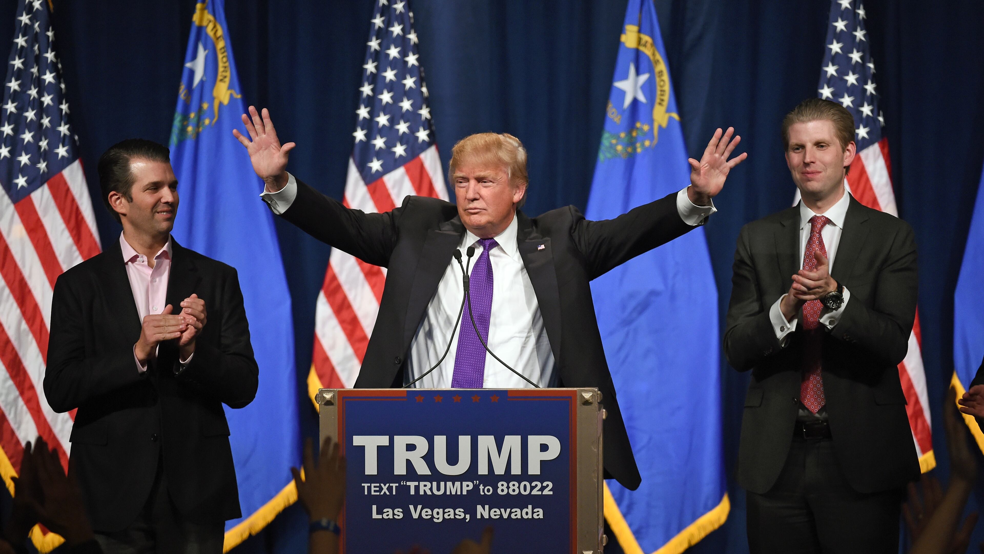 Republican presidential candidate Donald Trump (C) speaks as his sons Donald Trump Jr. (L) and Eric Trump (R) look on during a caucus night watch party at the Treasure Island Hotel & Casino on February 23, 2016 in Las Vegas, Nevada. The New York businessman won his third state victory in a row in the "first in the West" caucuses. (Photo by Ethan Miller/Getty Images)