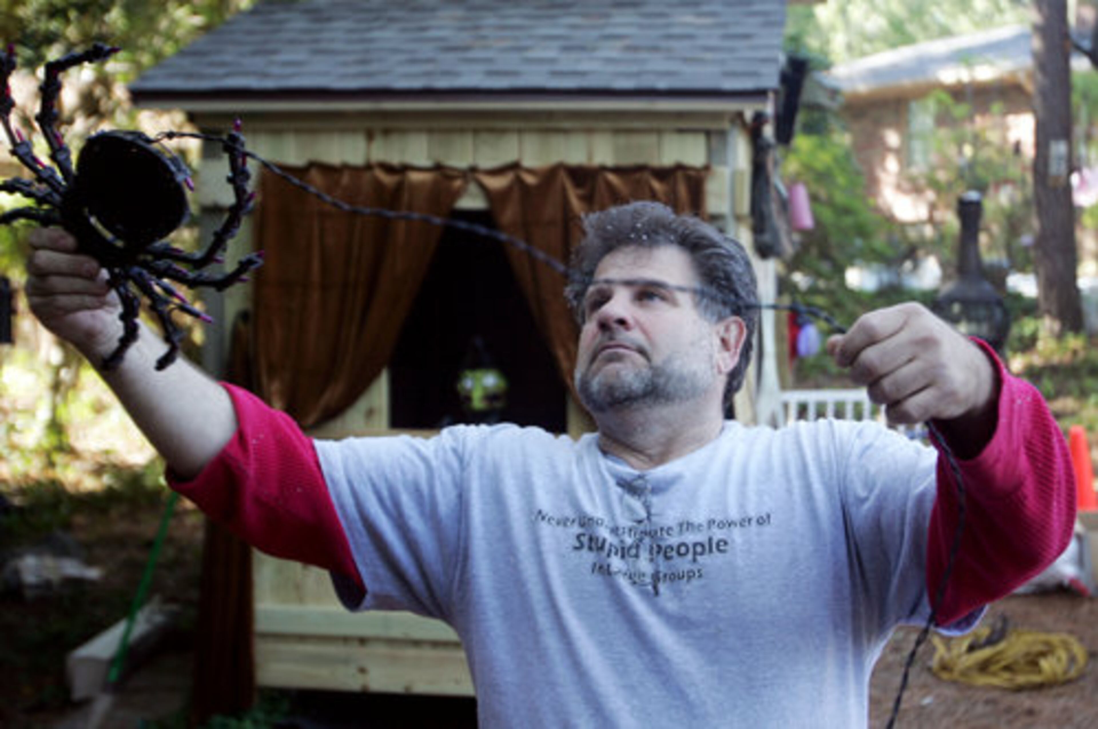 "What this has become is a real community event," said City Councilman Tibby DeJulio, who represents the area where Psathas, seen here deocrating, lives. "I've been going for some time, and I look forward to it each year."