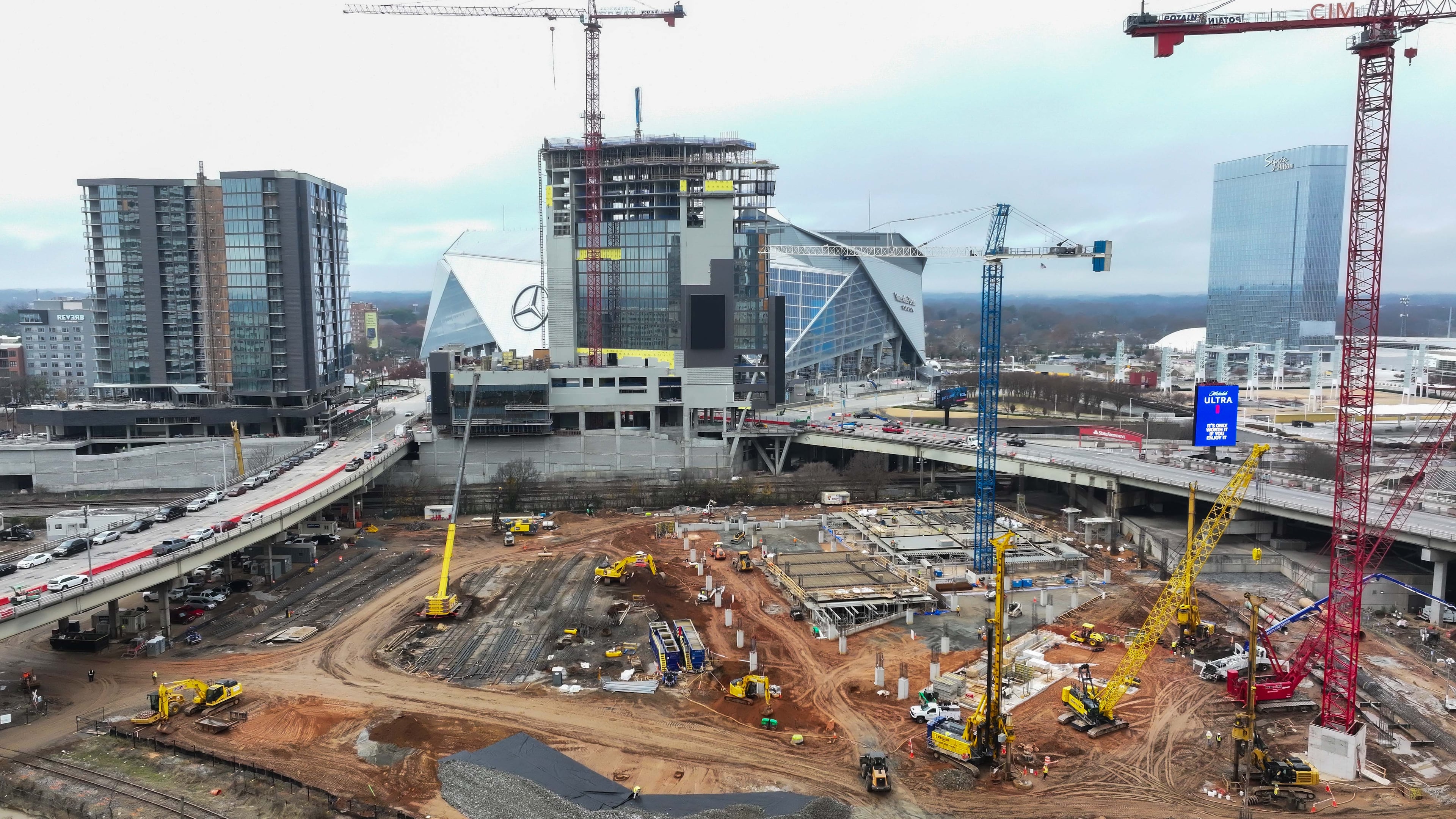 The Centennial Yards construction site is seen at full speed as the projects reach milestones. The Phoenix Hotel (center) reached the highest point in the structure on Wednesday. Miguel Martinez/AJC