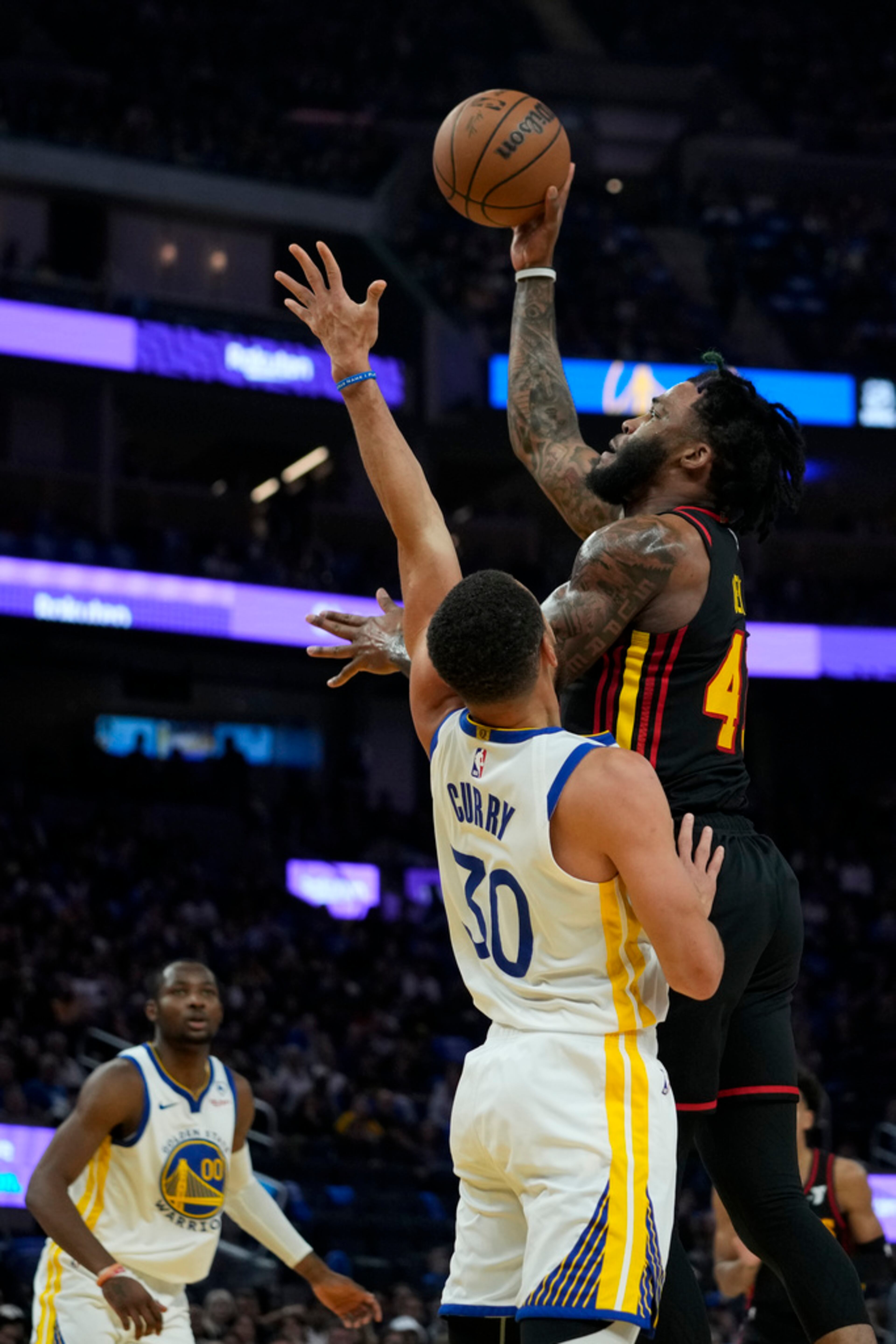 Atlanta Hawks forward Saddiq Bey, right, shoots over Golden State Warriors guard Stephen Curry during the first half of an NBA basketball game, Wednesday, Jan. 24, 2024, in San Francisco. (AP Photo/Godofredo A. Vásquez)