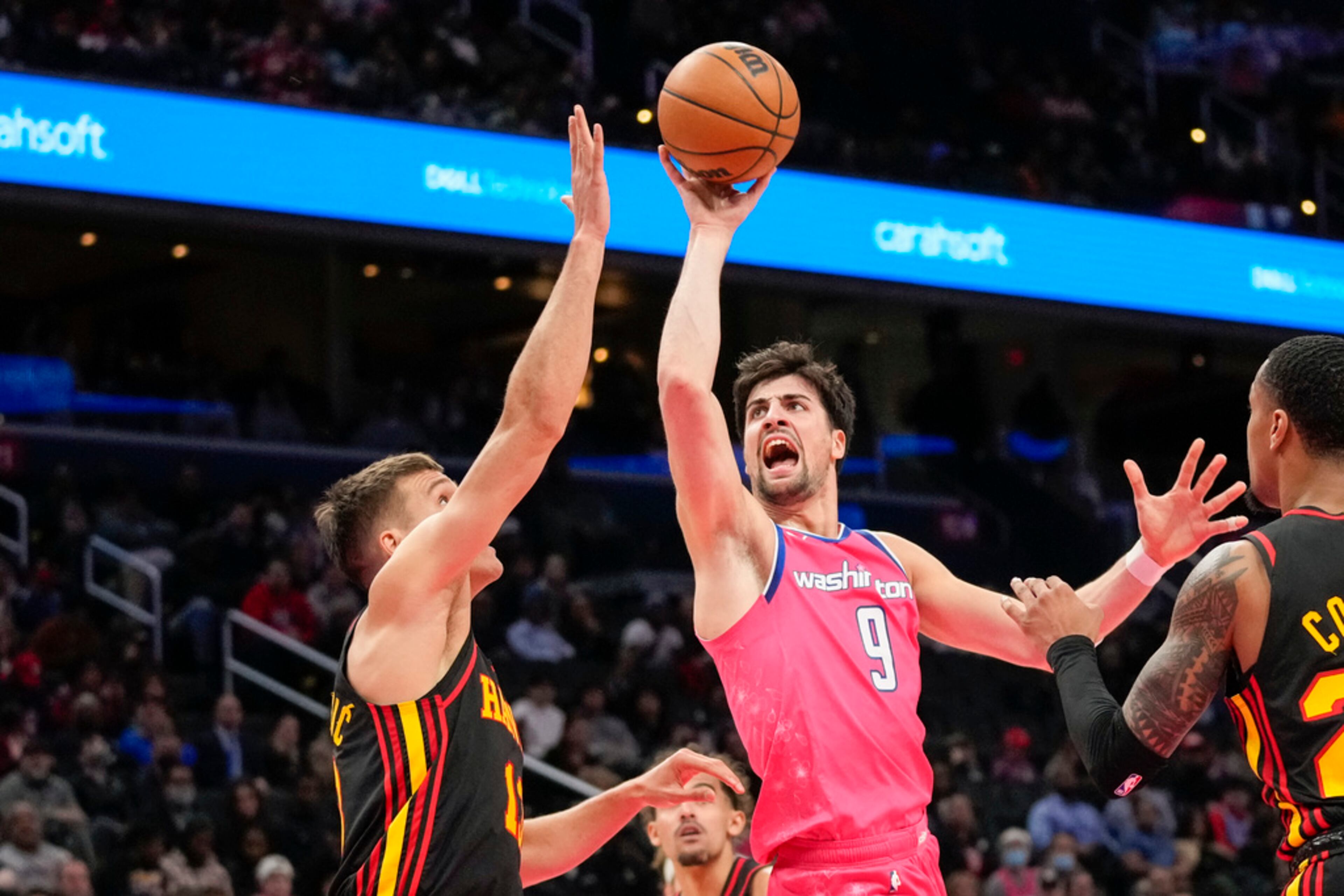 Atlanta Hawks guard Bogdan Bogdanovic, left, guards Washington Wizards forward Deni Avdija (9) during the first half of an NBA basketball game Wednesday, March 8, 2023, in Washington. (AP Photo/Alex Brandon)