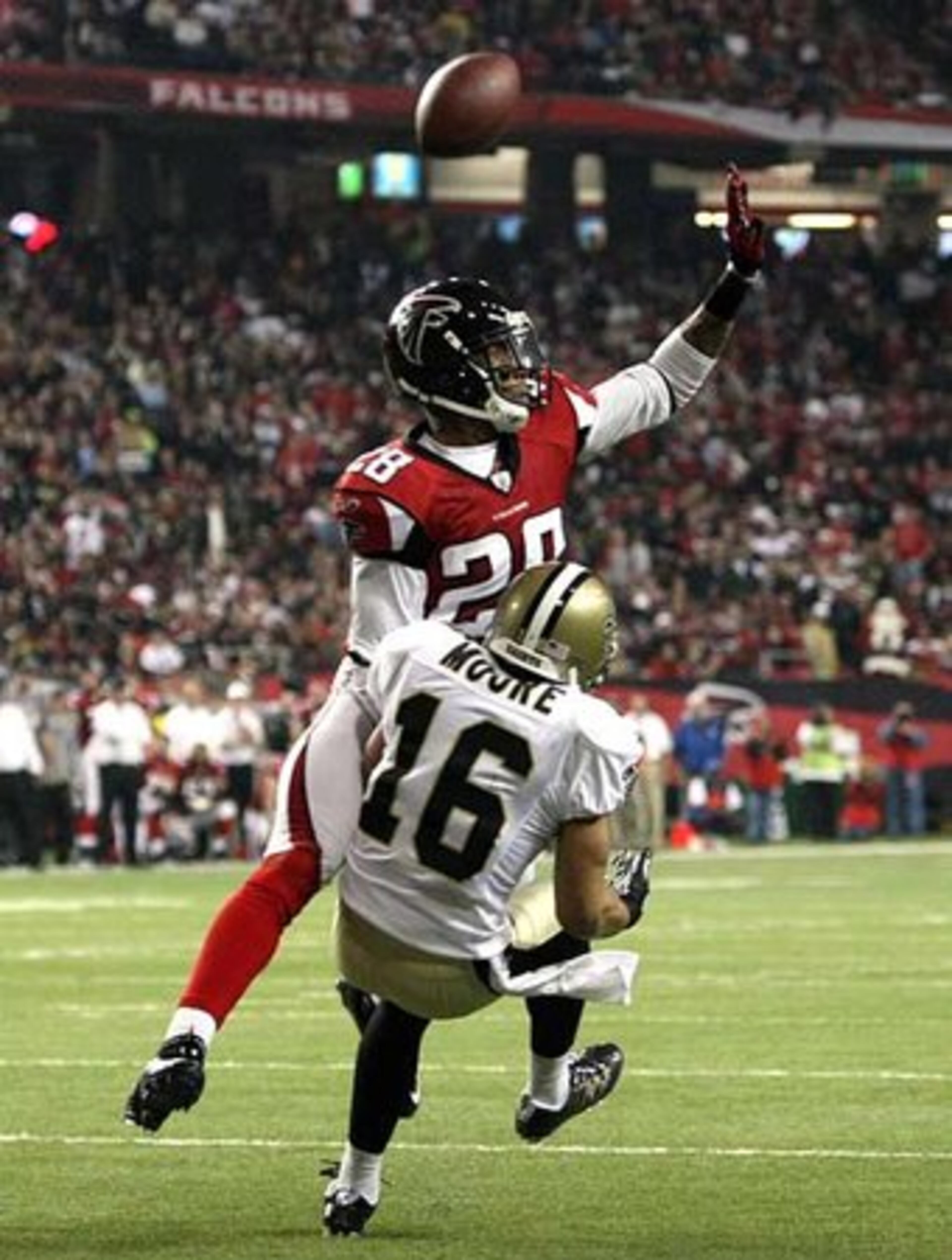 Falcons safety Thomas DeCoud (28) deflects a pass intended for New Orleans Saints wide receiver Lance Moore (16).