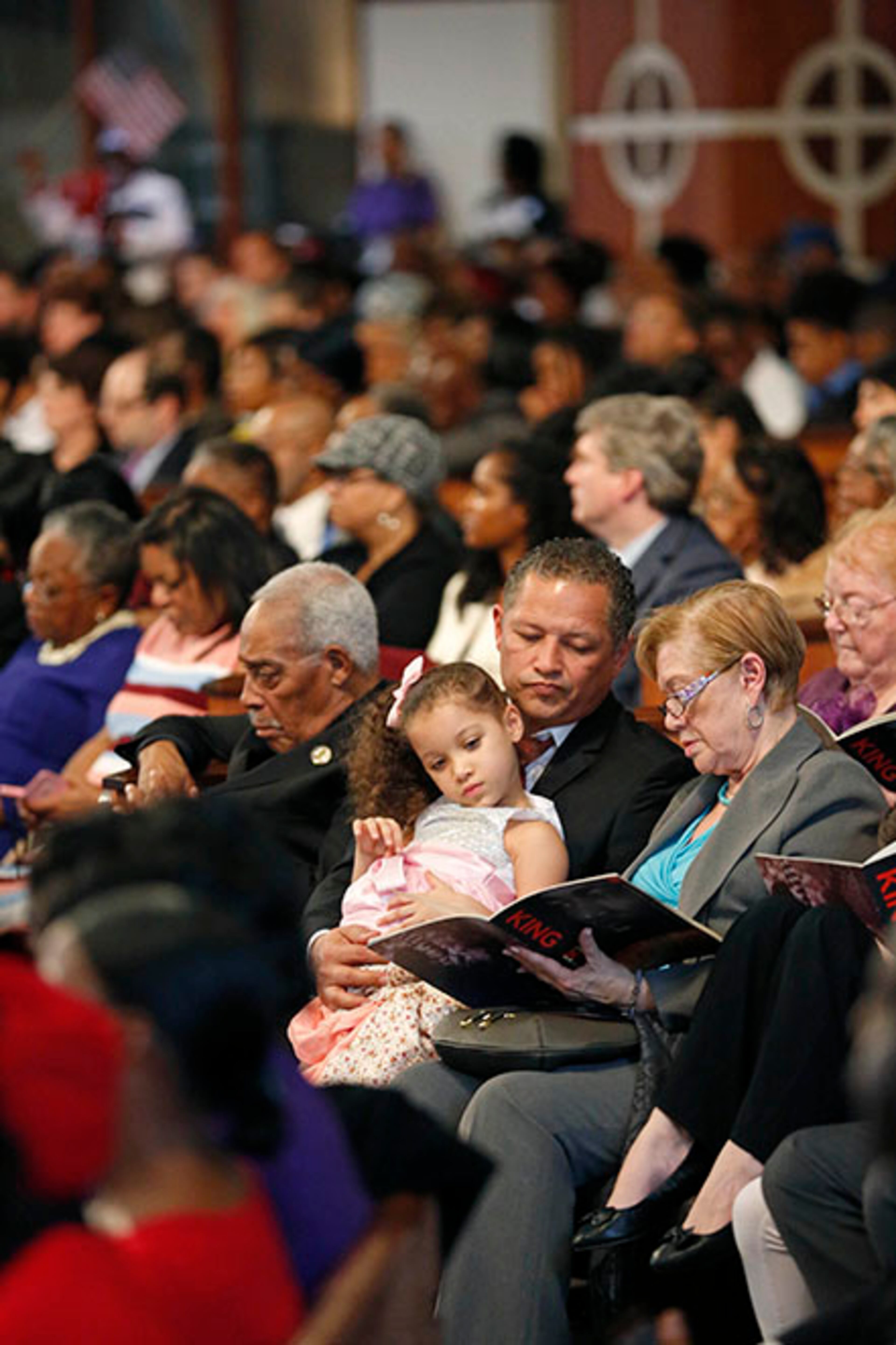 January 16, 2017 - Atlanta, Ga: Spectators look through a program during the 49th annual Martin Luther King Jr. Commemorative Service at Ebenezer Baptist Church Monday, January 16, 2017, in Atlanta, Ga. PHOTO / JASON GETZ