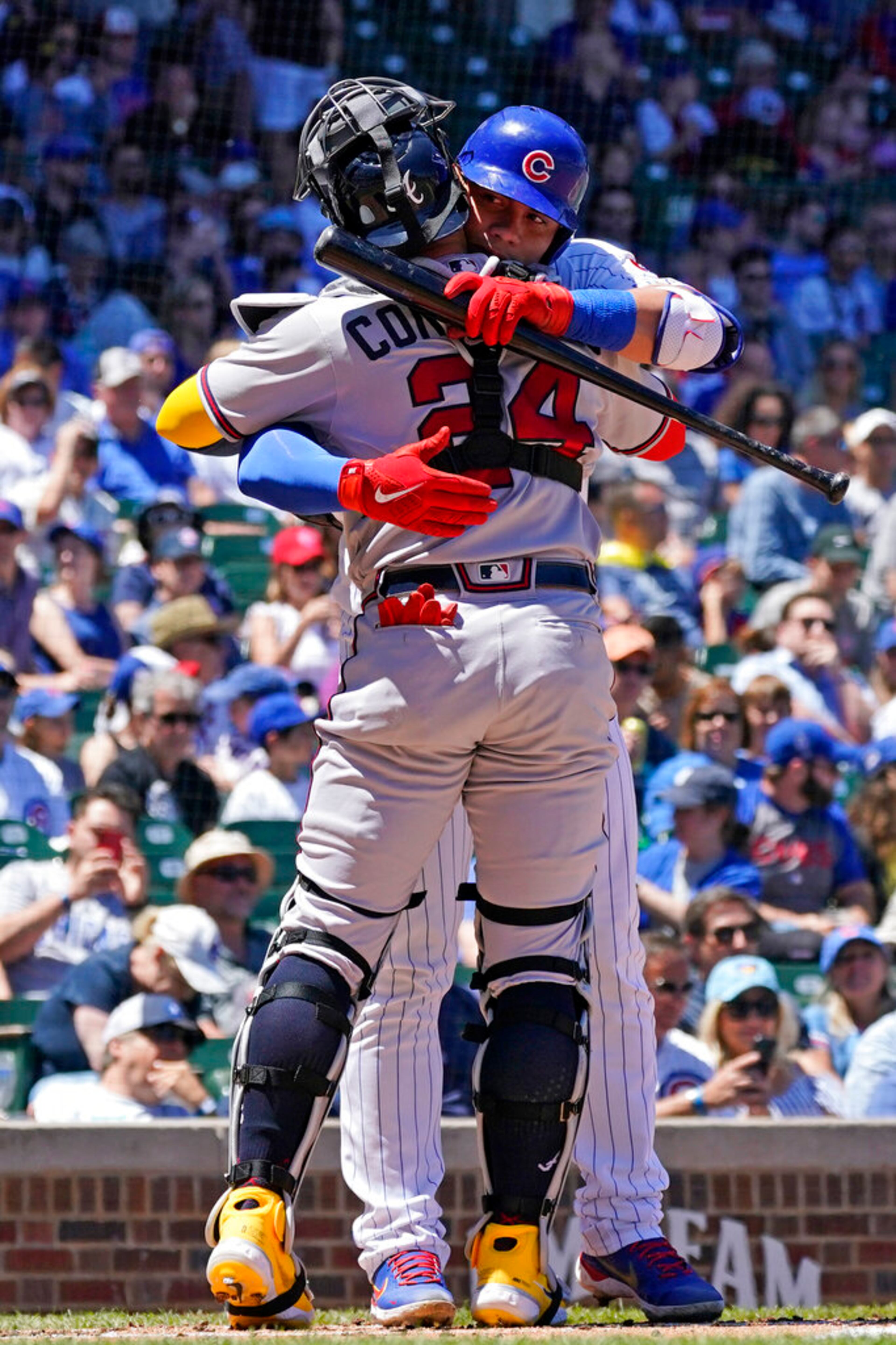 Chicago Cubs' Willson Contreras, right, hugs his brother Atlanta Braves catcher William Contreras during the first inning of a baseball game in Chicago, Saturday, June 18, 2022. (AP Photo/Nam Y. Huh)