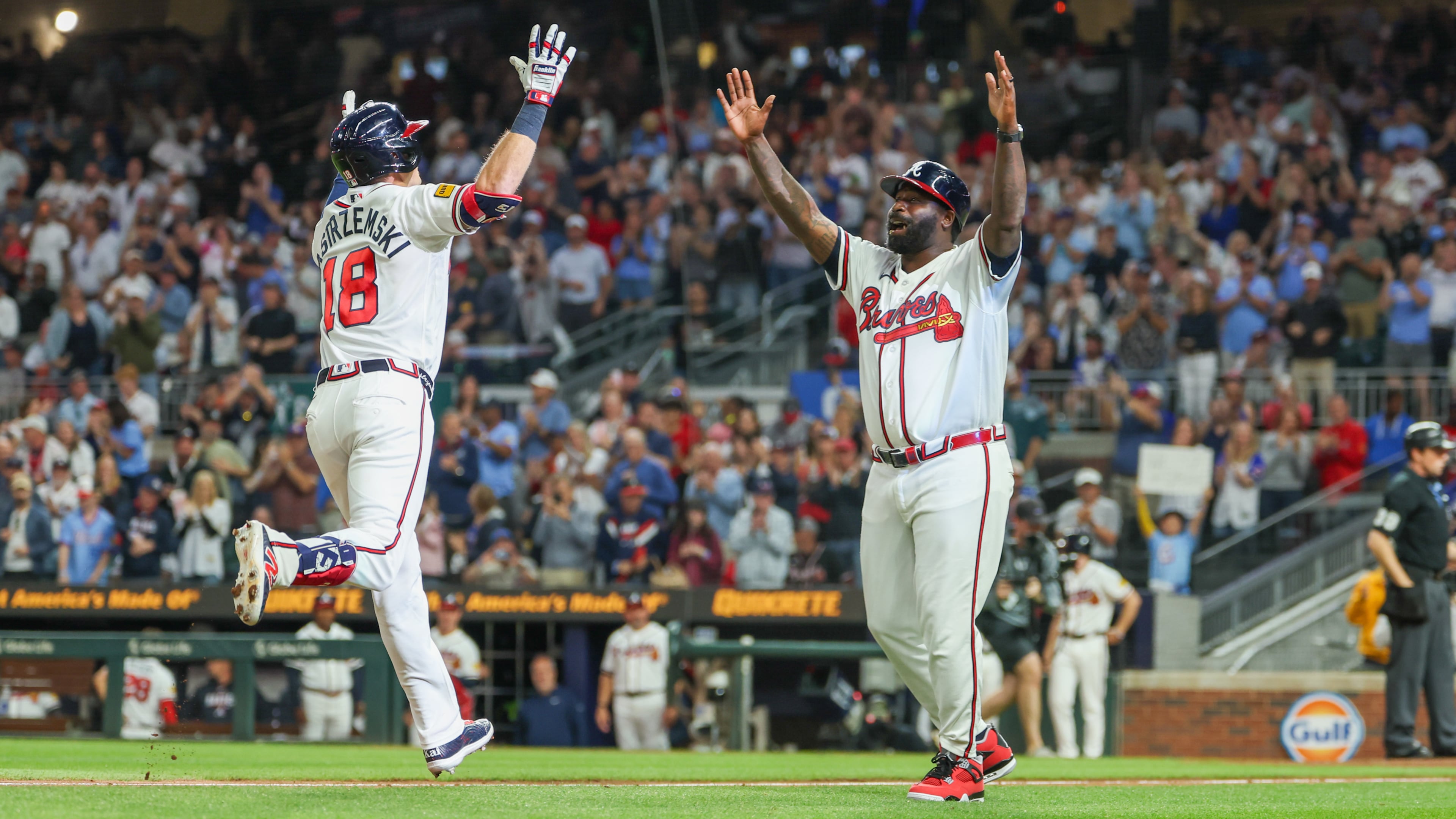 Atlanta Braves left fielder Mike Yastrzemski (18) celebrates with Atlanta Braves third base coach Tommy Watkins (84) after hitting a home run in the fifth inning of the Braves versus Cubs game at Truist Park in Atlanta on May 12, 2026. (Arvin Temkar/AJC)