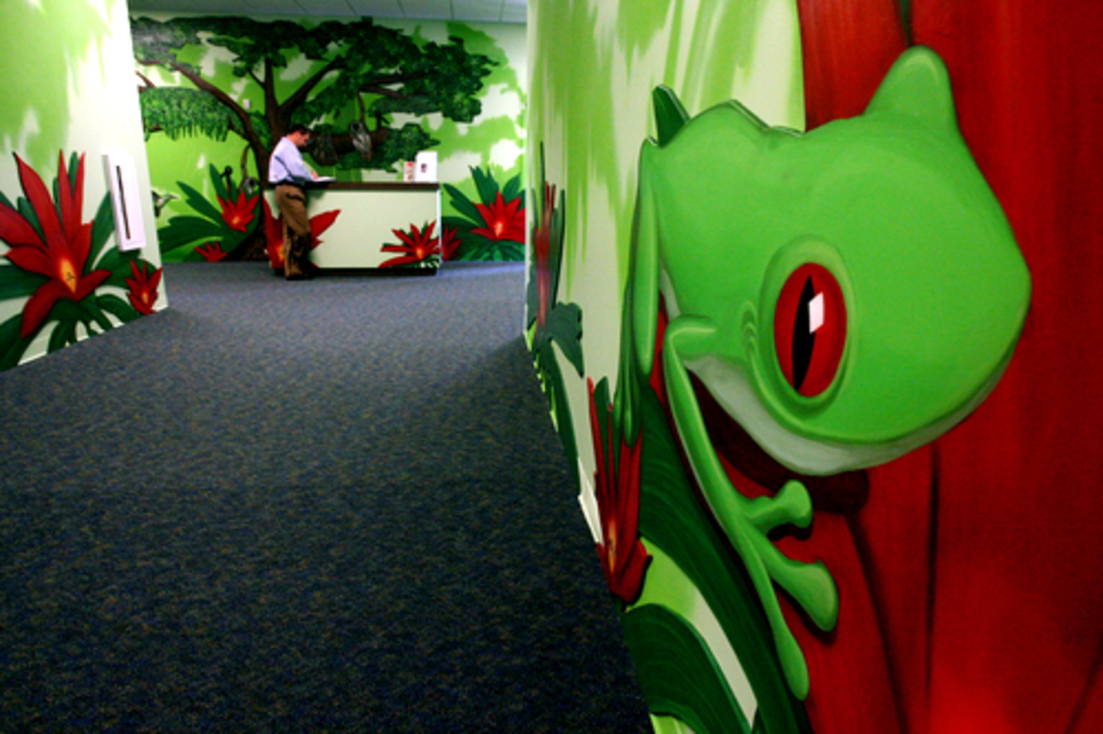 A brightly-colored tree frog welcomes small children (babies to young toddlers) to the "Amazon Crossing" childcare area.