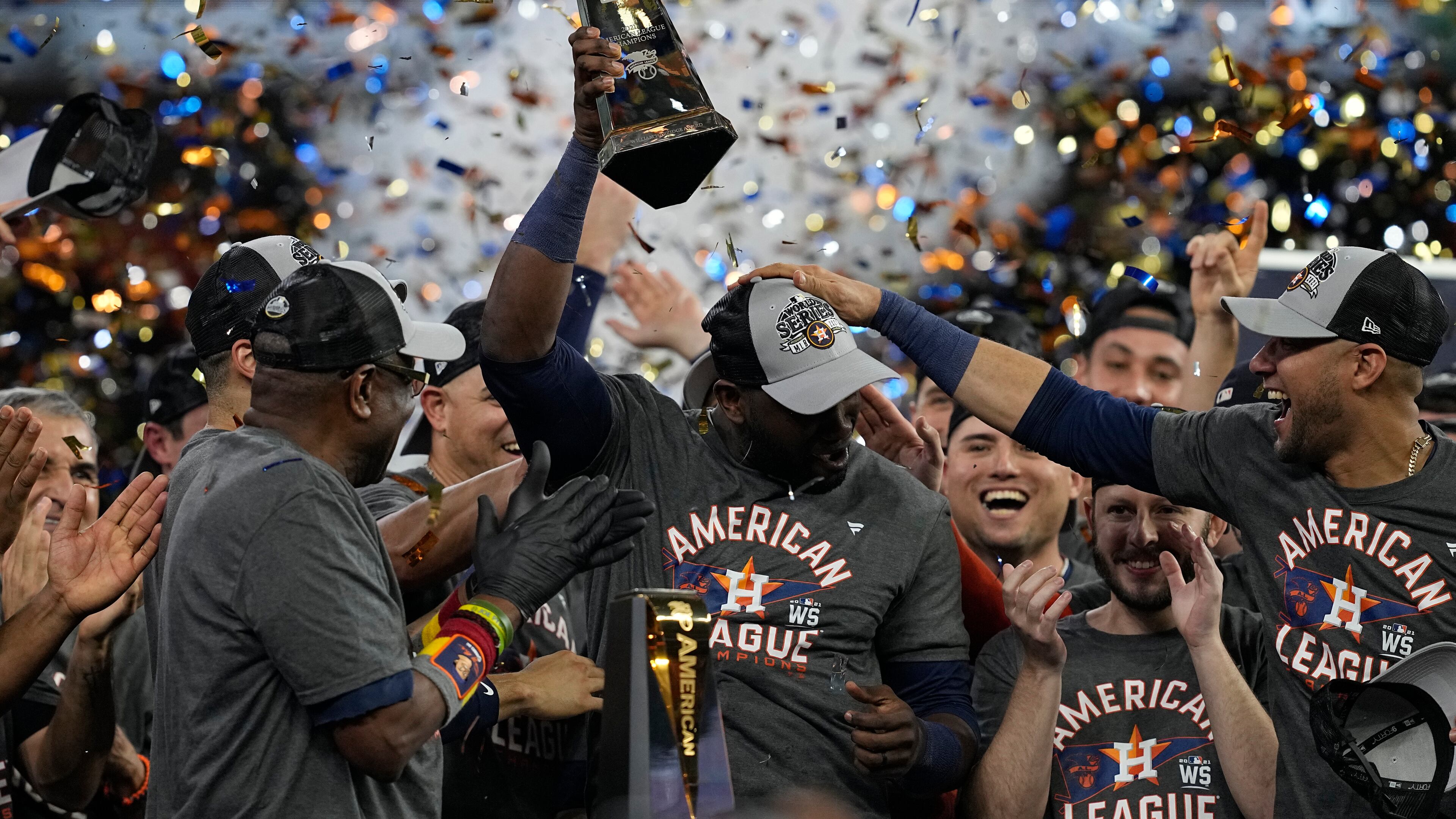 Houston Astros designated hitter Yordan Alvarez holds the trophy after their win against the Boston Red Sox in Game 6 of baseball's American League Championship Series Friday, Oct. 22, 2021, in Houston. The Astros won 5-0, to win the ALCS series in game six.(AP Photo/Tony Gutierrez)