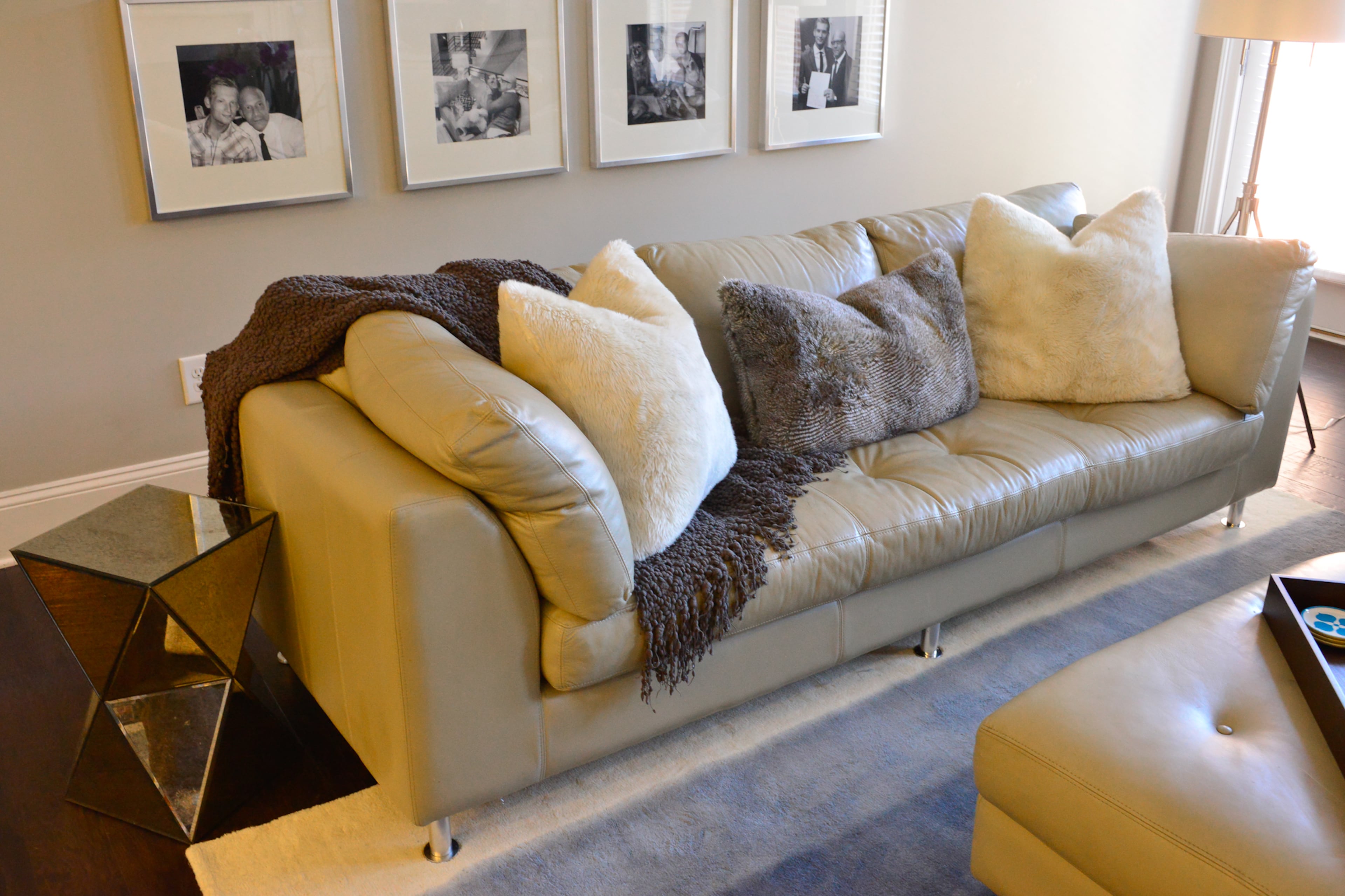 Austin Williams Carino designed the leather couch with stainless steel legs to bring a contemporary look into the traditional living room. Having the matching ottoman was a must for Johnny Carino, who typically has had large traditional furniture, so he can pull the ottoman up to the couch and stretch out.