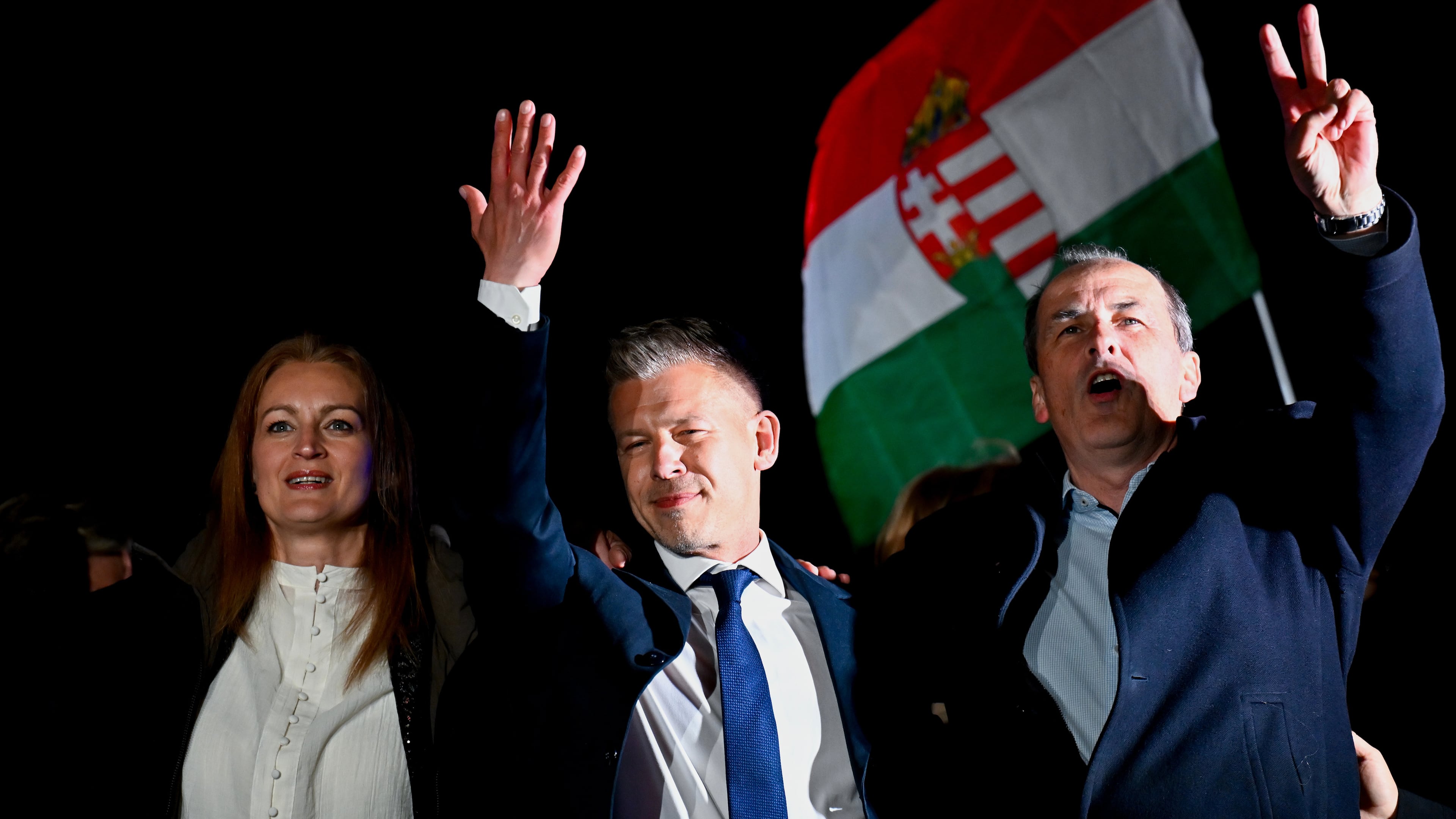 Peter Magyar, leader of the opposition Tisza party, center, celebrates with his party colleagues following the announcement of the partial results of the parliamentary election, in Budapest, Hungary, Sunday, April 12, 2026. (AP Photo/Denes Erdos)